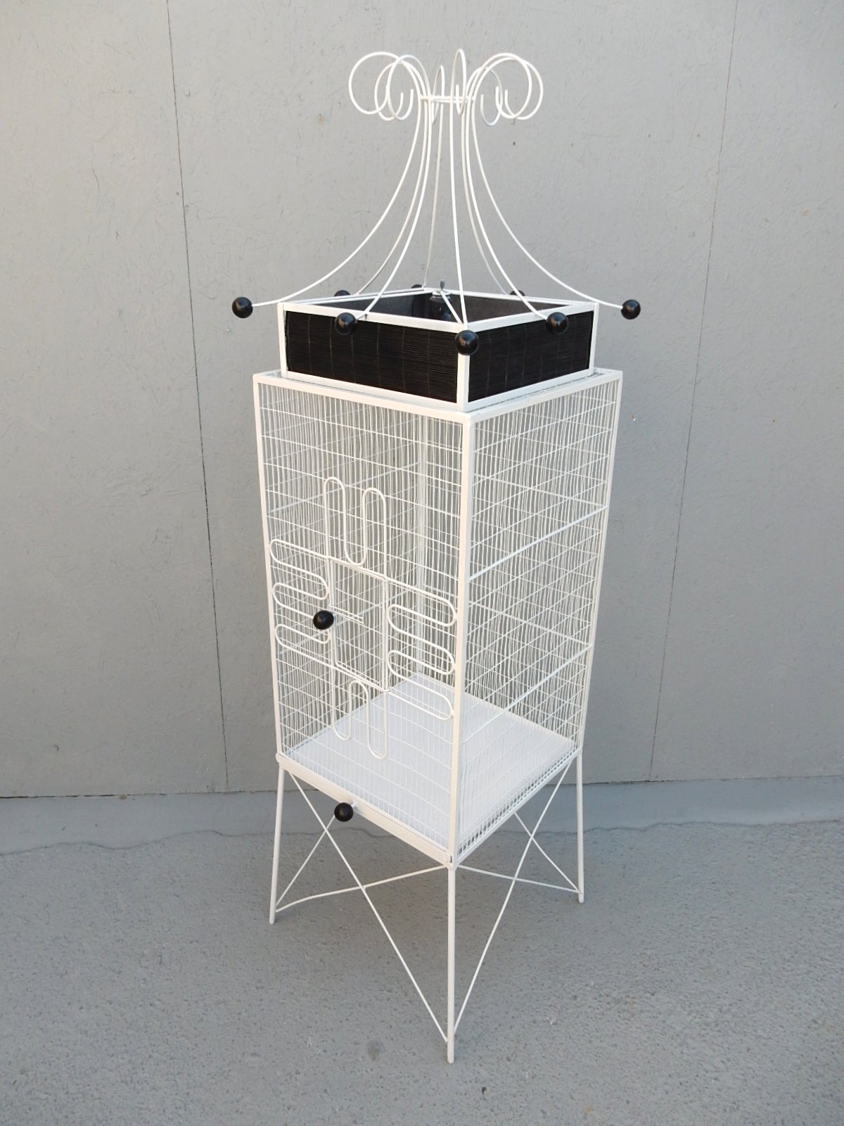 Outstanding full size sculptural metal and wood birdcage by designer Frederick Weinberg.
Clean with new enamel paint. Bulb socket in top with black bamboo shade sides.