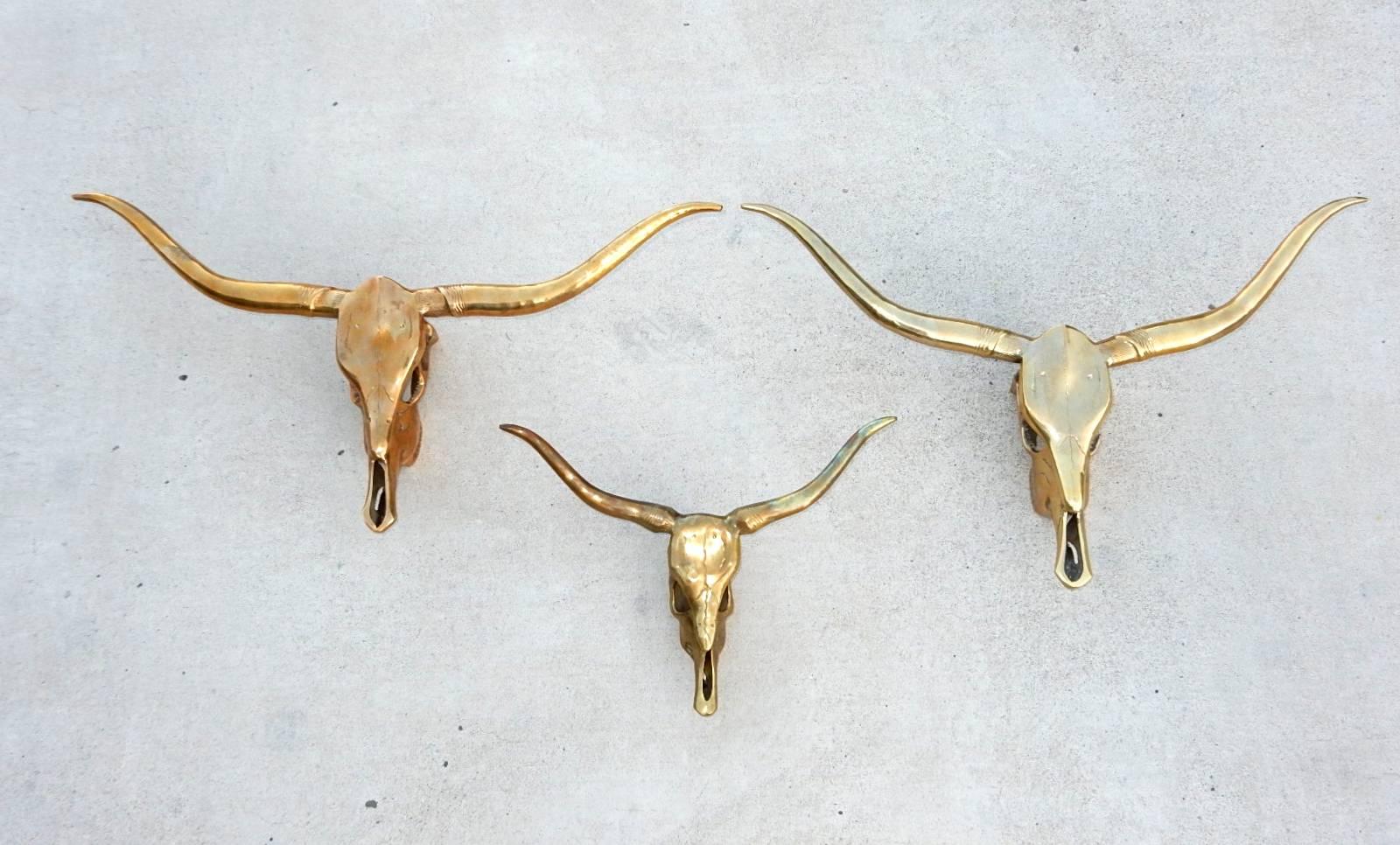 This listing is for three brass sculptures of longhorn steer skulls from the 1970s.
Eclectic home decor pieces.
Largest spans 31 inch across, followed by 28 inch and 16 inch across.
 