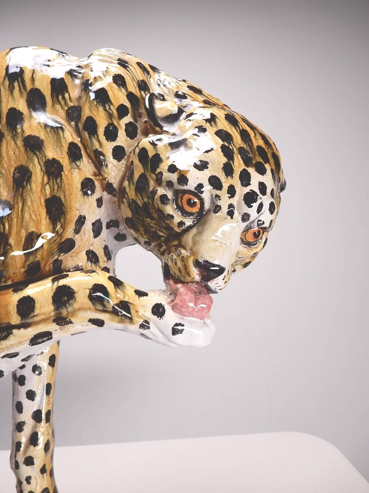 Hand-painted Italian ceramic cheetah floor sculpture mounted on a wood plinth, circa 1960s.
Exotic home decor. Incredible detail.