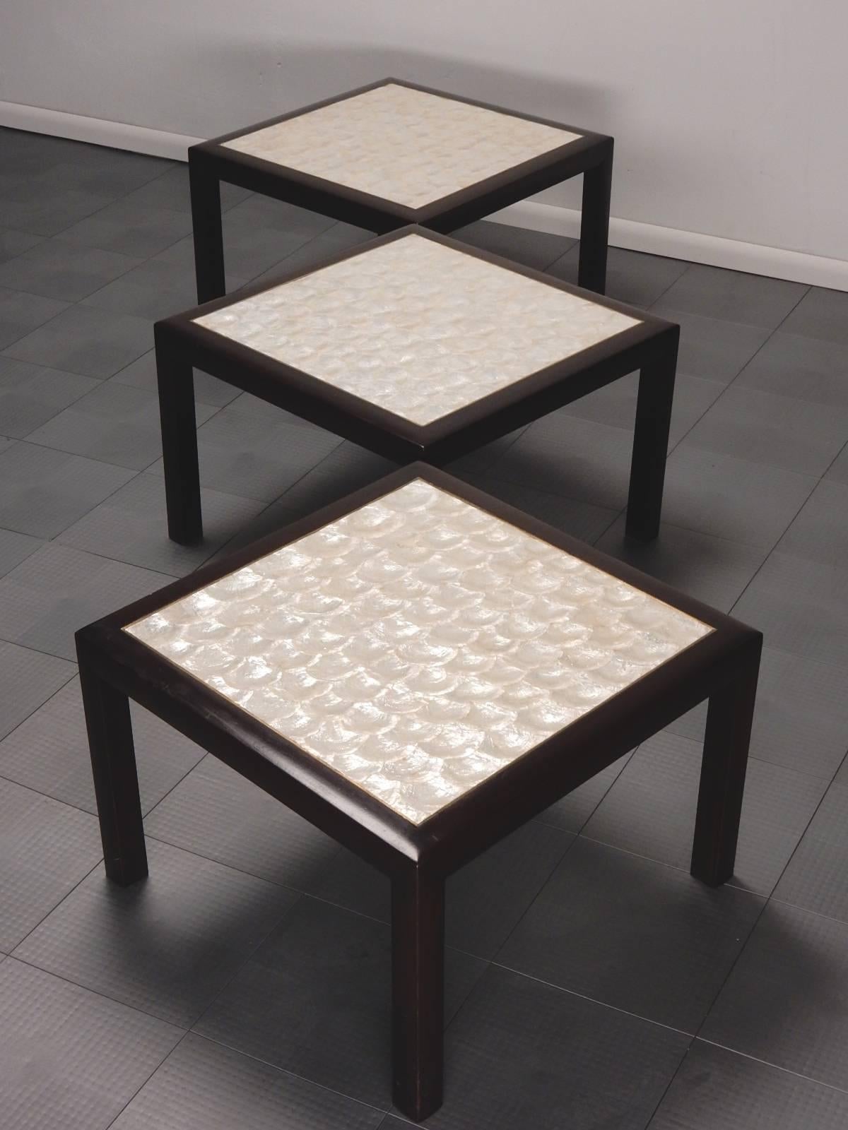 Set of three lacquered mahogany Parsons tables with polished brass top trim and pearly Capiz shell inlay.
Can be used together as a cocktail table or individually.
Extraordinary custom crafted tables, circa 1960s.
These are in excellent