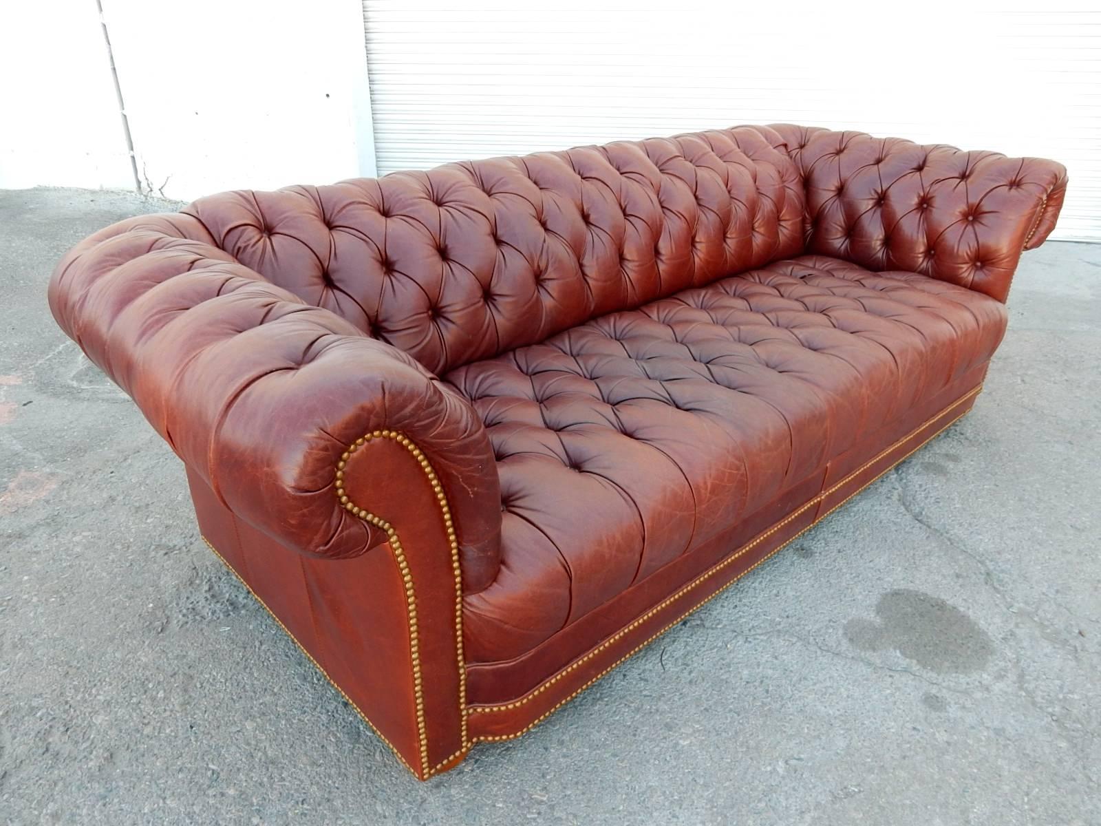 Gorgeous distressed leather Chesterfield sofa in oxblood color with brass tack trim.
Worn to perfection with subtle grain and patina. 
Soft and plush with no holes or tears.