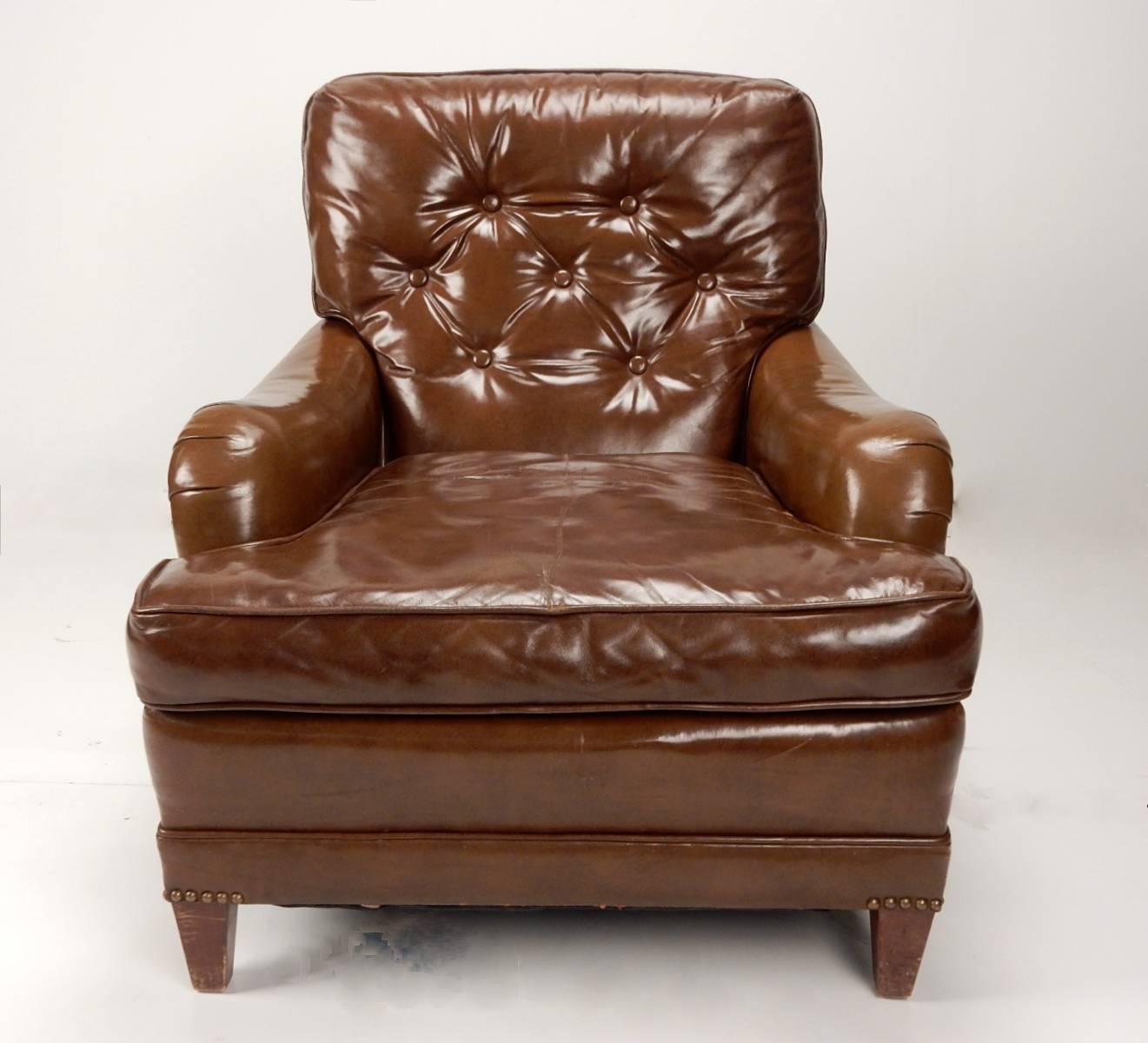 Premium glazed cognac brown leather trimmed in bronze dome tacks make these captivating club chairs and ottoman the right choice for den, library or ultra Classic living room,
circa 1940, American, showing outstanding quality and craftsmanship.
Very