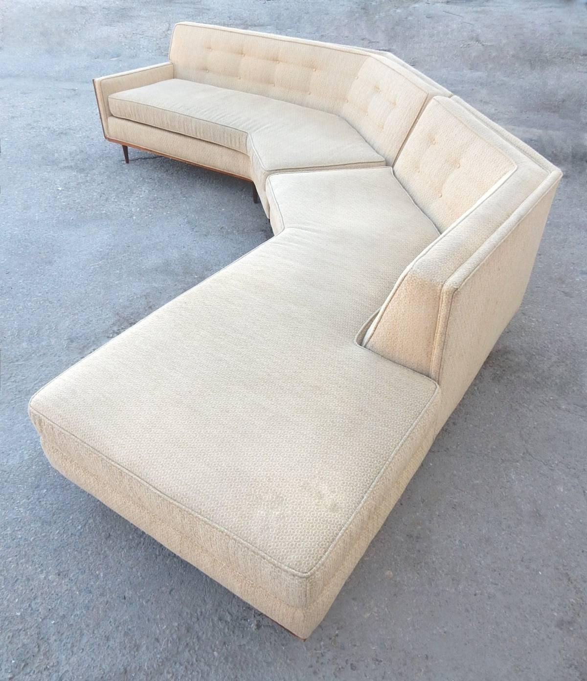 Tasty 12 foot long sectional sofa, circa 1960. Cane end panel and surround seating opposite end. Wood trimmed lower edge with thin tapered legs. Tufted back in a tan colored upholstery.
No manufacturer tag. Very in the style of Harvey Probber