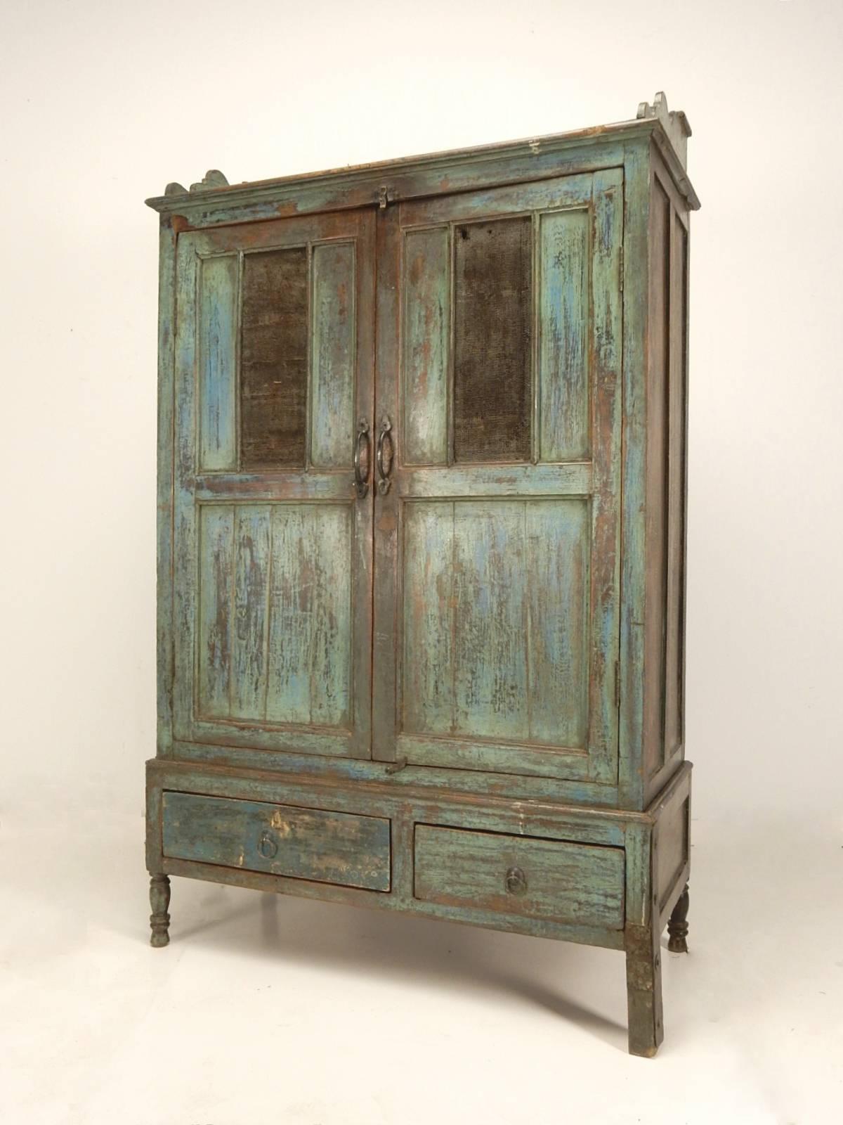 Primitive painted pie safe cabinet, circa 1890s.
Striking multi layer paint on face. Double cabinet top with double drawer base.
Screen panels on each cabinet door.
Two-piece separating at drawer base. Ancient front right leg repair is