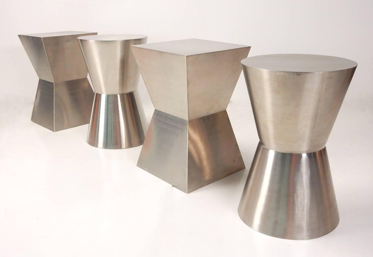 Set of four custom-made seamless stainless steel tables or stools.
Heavy well-crafted and unique.
Two rectangular and two hourglass shapes.