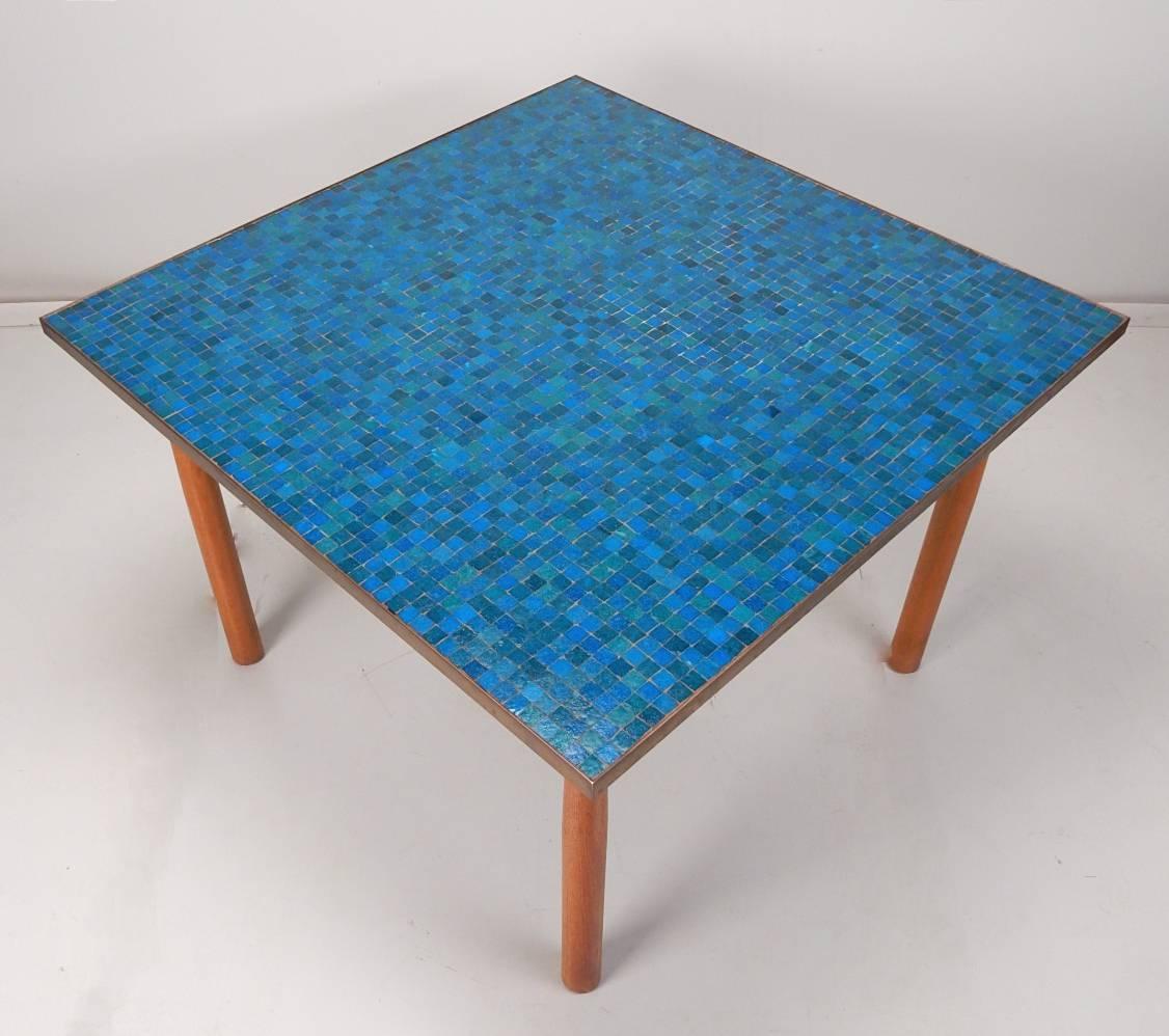 Rare 1940s Edward Wormley design for Dunbar Furniture mosaic glass tile 42 inch square dining table top. Blue and green glass tile top inlaid in a brass frame with tapered Mahogany legs. Dunbar badge on the underside of top. Gorgeous piece of art