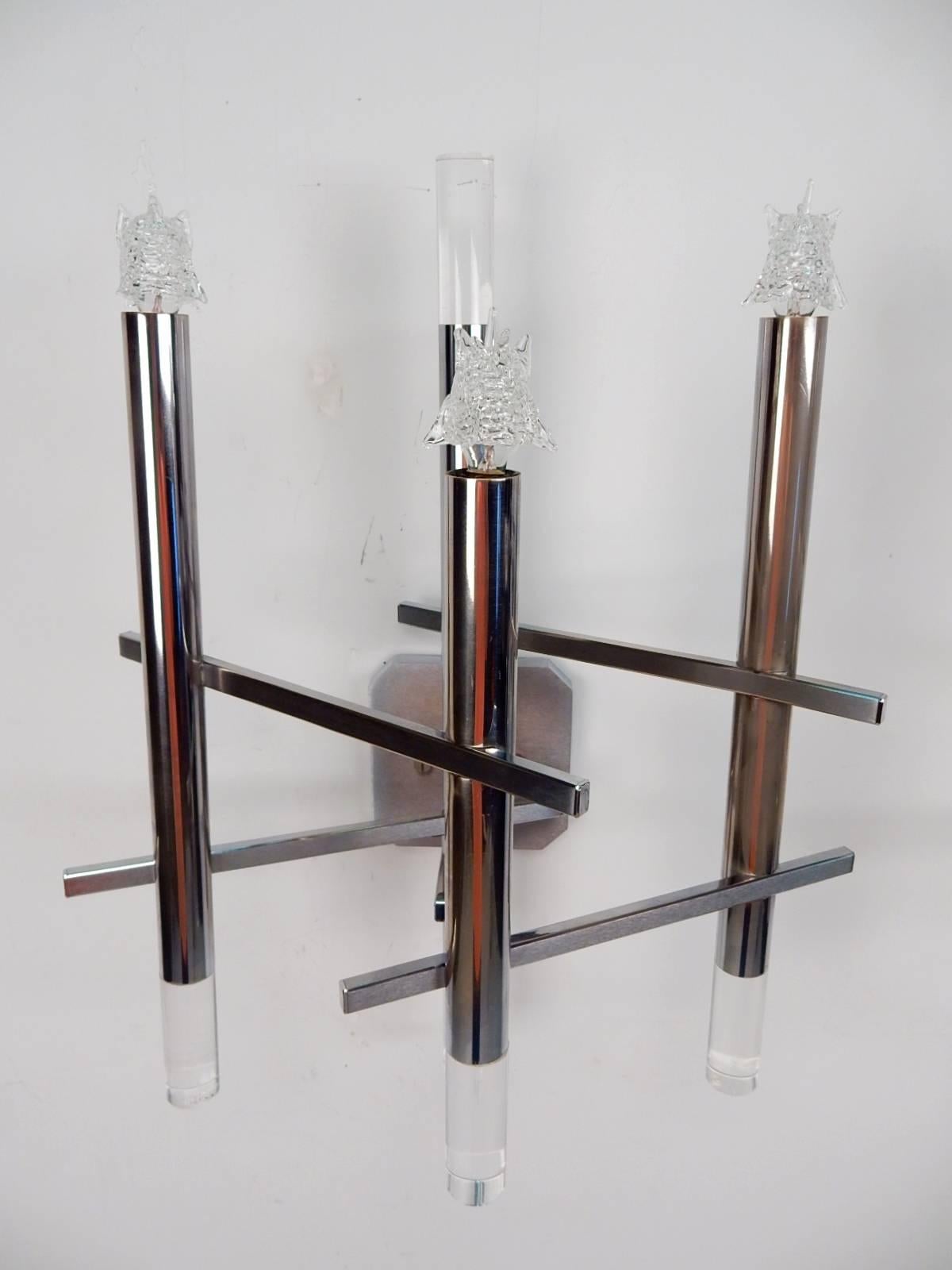 Ultra cool Italian chrome and Lucite wall sconce lamp pair designed by Gaetano Sciolari, circa 1970s.
Asymmetrical chrome candle stick forms with Lucite caps and starlight bulbs.
Both signed Sciolari on rear of wall cap. 
Perfect working order