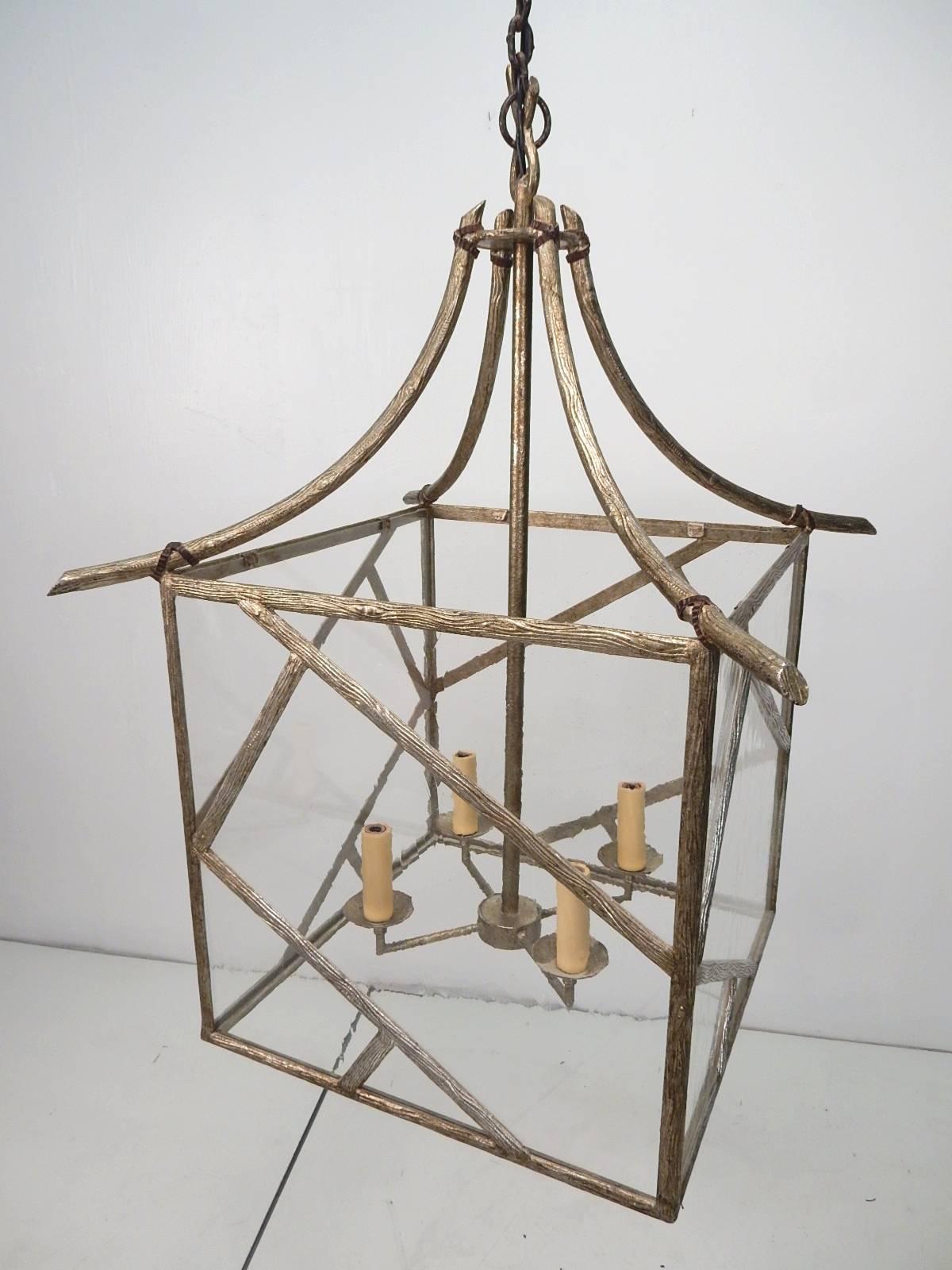 Enormous faux bois twig Pagoda chandelier made of brass with platinum finish, circa 1970s
Over 2 feet wide and 3 feet tall with 6 foot wrought iron/hand-forged chain and 8 inch wide matching ceiling cap.
Thick mineral glass sides, four candle bulb