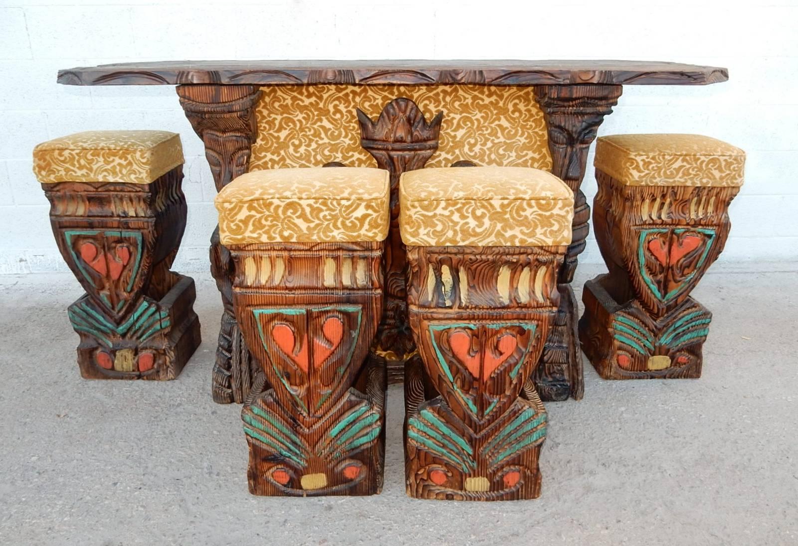 Hand-sculpted swamp cedar dry bar with four polychrome stools by William Westenhaver or Witco, circa 1960s.
Flocked velvet upholstery on stools and face of bar. Male and female figures on each side of front with armour shield in centre.
The front