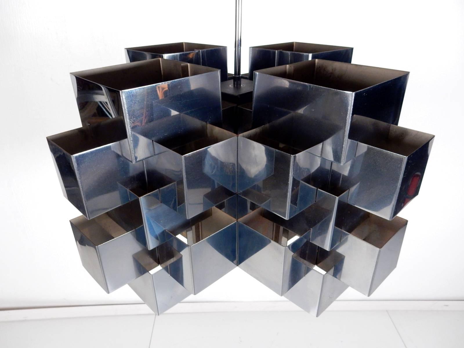 Signed and dated 1975 ‘Cubist’ chandelier by Curtis Jere.
Polished stainless steel (like chrome). Light reflects throughout the panels.
Takes four standard size light bulbs. 24 inch drop from ceiling to bottom edge.