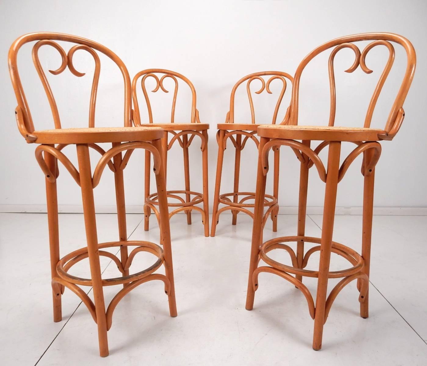 Set of four mid-20th century Thonet style bentwood cane bar stools with back rests.
Tall, counter height stools with footrest. Marked made in Romania.
All four are in very good condition, solid with no issues.
Cane seating in free of holes or