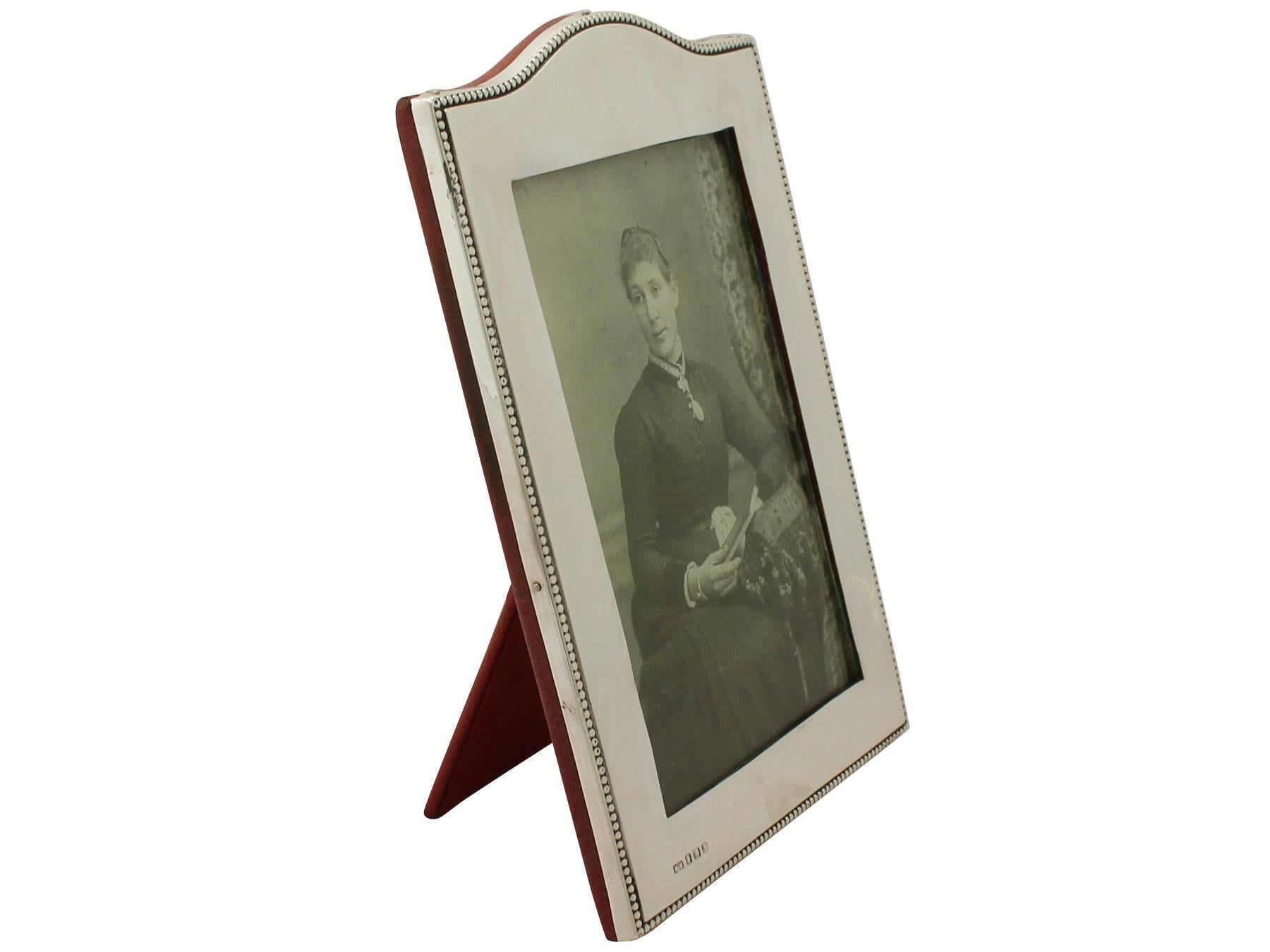 A fine and impressive antique George V English sterling silver photograph frame; an addition to our ornamental silverware collection.

This fine antique George V sterling silver photo frame has a rectangular form with domed upper portion and a
