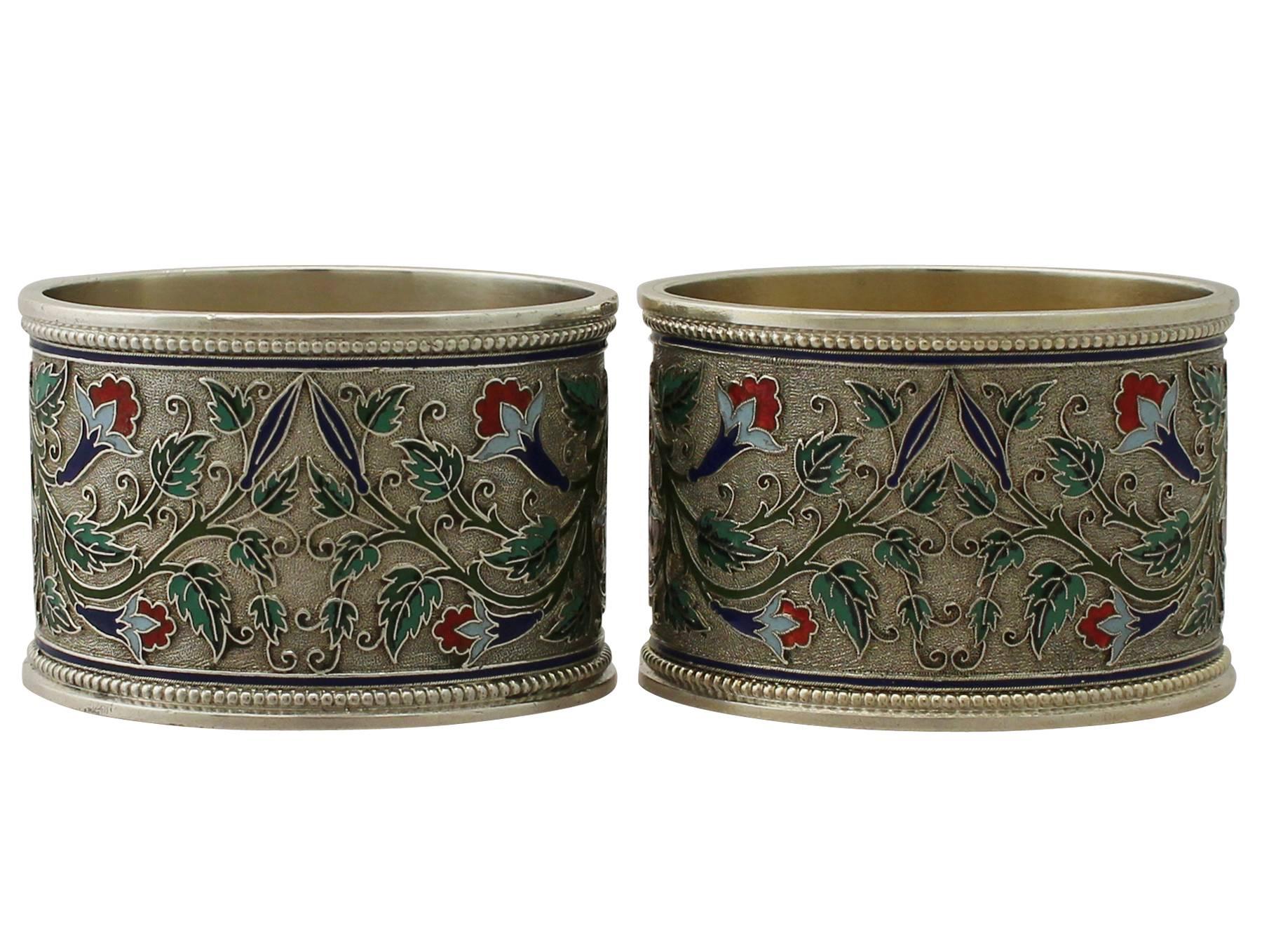 An exceptional, fine and impressive pair of antique Russian silver gilt and polychrome cloisonné enamel napkin rings; an addition to our collection of dining silverware.

These exceptional antique Russian silver gilt and polychrome cloisonné