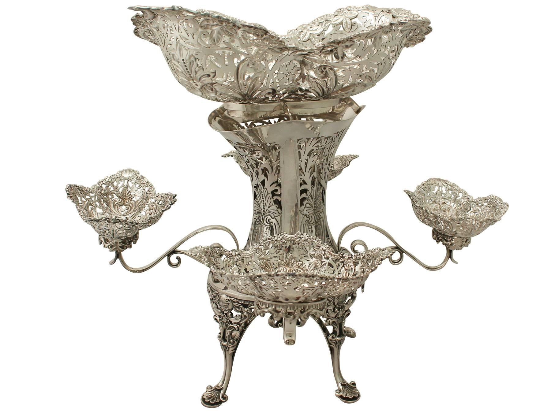An exceptional, fine and impressive antique Edwardian English sterling silver epergne/centerpiece; an addition to our ornamental silverware collection.

This magnificent Edwardian sterling silver centerpiece has an oval waisted shaped form supported