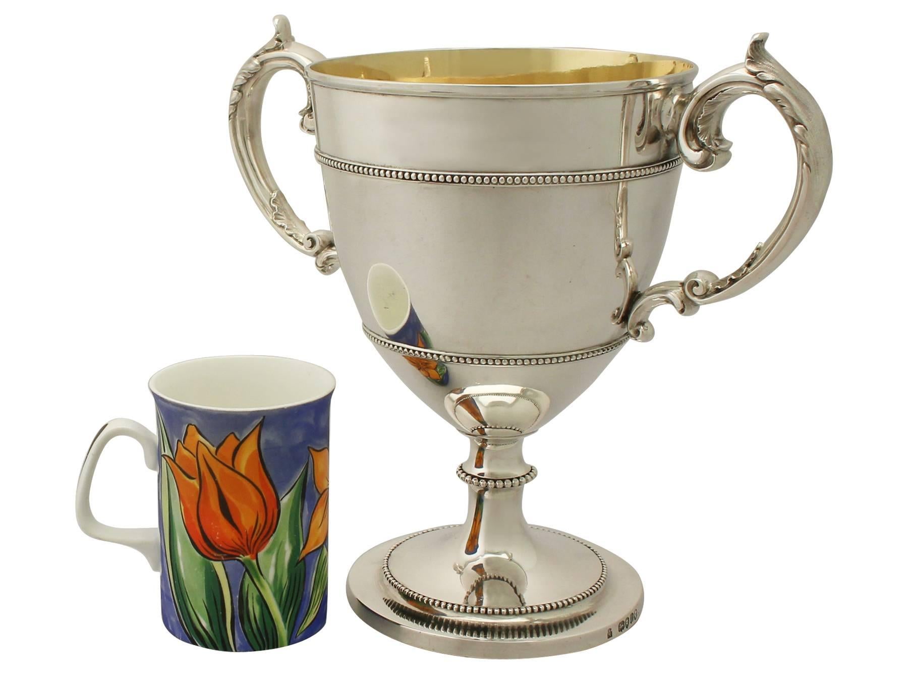 An exceptional, fine and impressive antique Victorian English sterling silver cup; an addition to our presentation silverware collection.

This exceptional antique Victorian sterling silver cup has a bell shaped form to a spreading pedestal