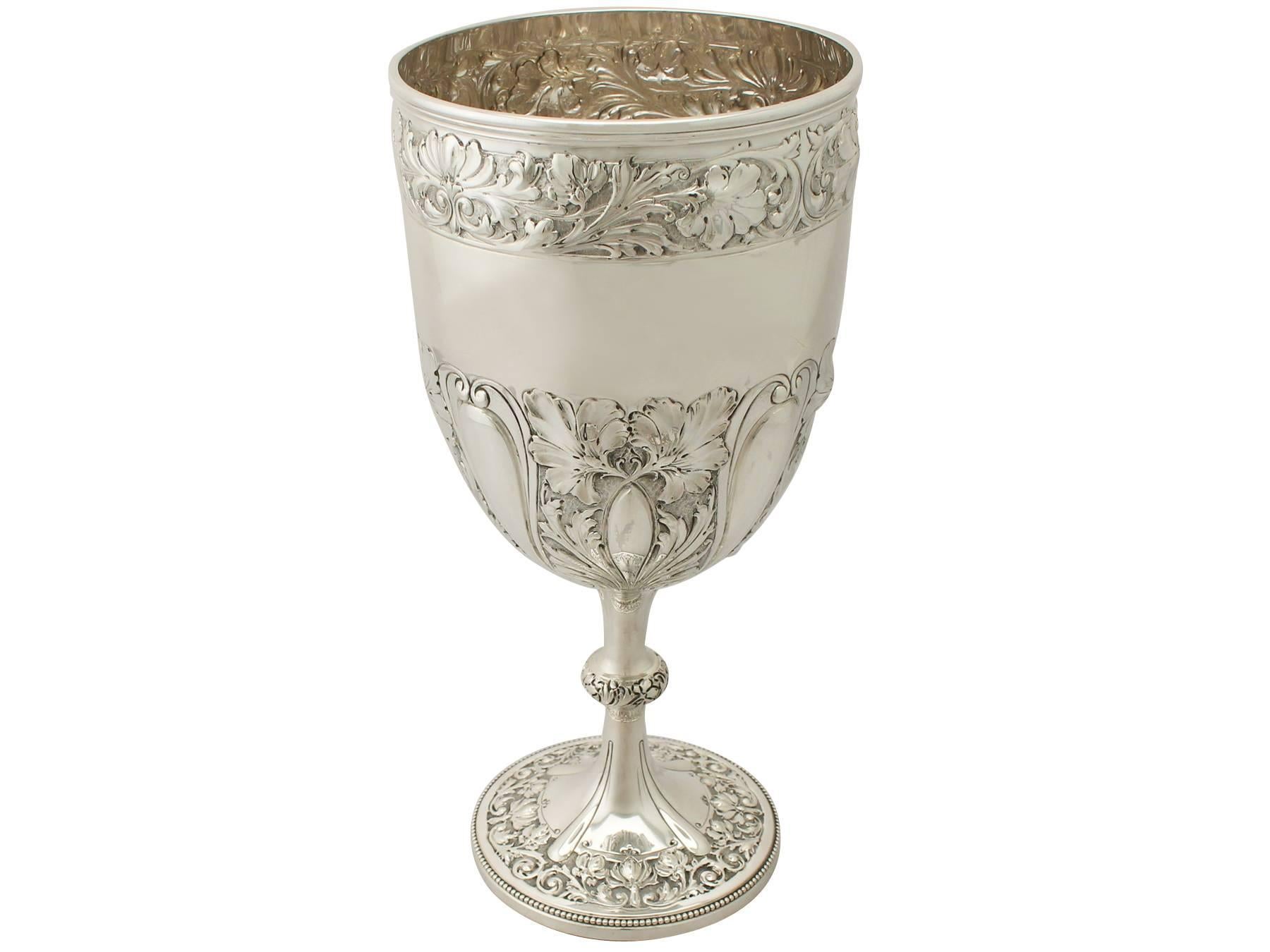 An exceptional, fine and impressive, large antique Victorian English sterling silver presentation cup; an addition to our presentation silverware collection.

This exceptional antique Victorian sterling silver presentation cup has a plain circular