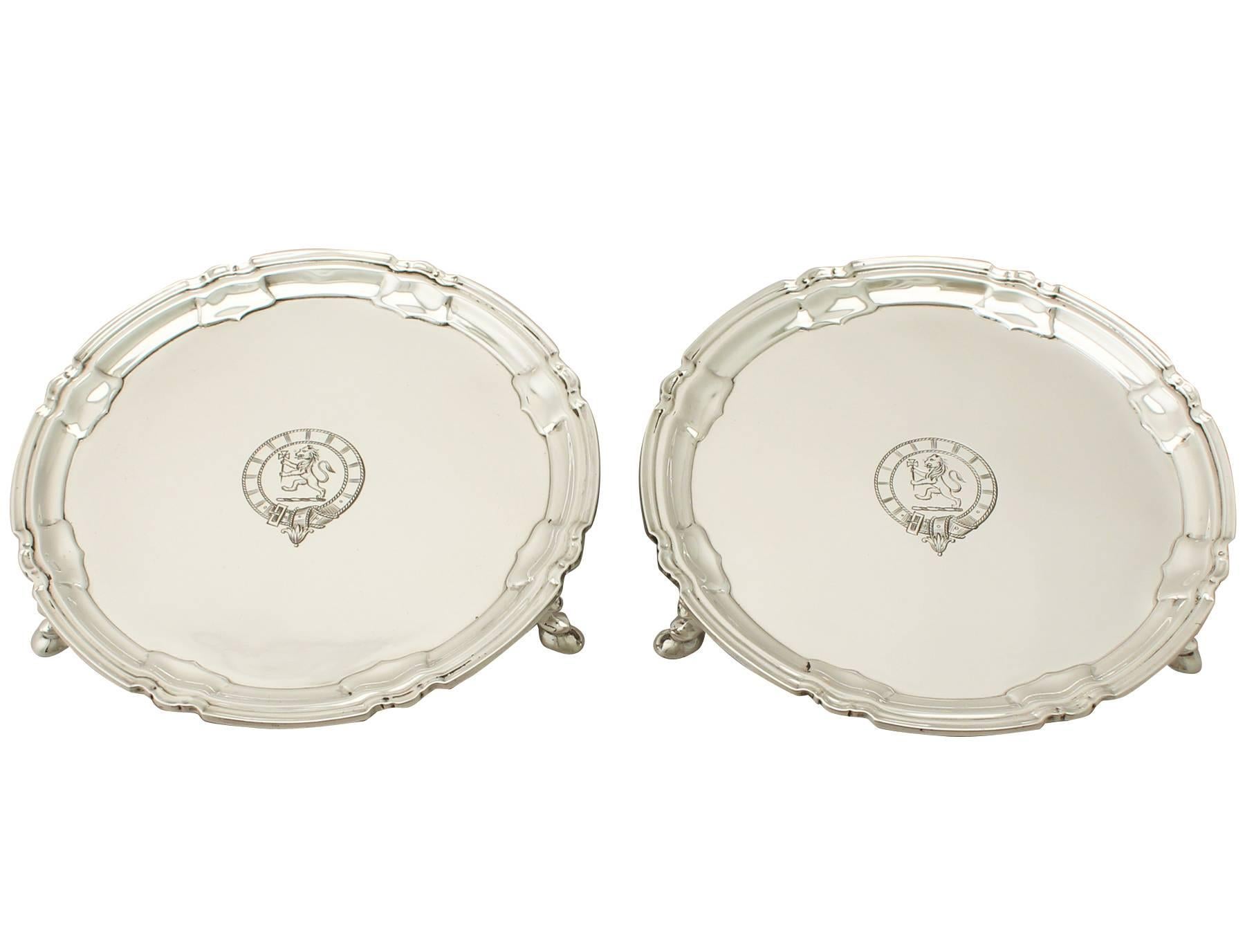 A fine and impressive pair of antique George V English sterling silver waiters; an addition to our silver tray, salver and platter collection.
These fine antique George II sterling silver waiters have a circular shaped form.

The plain surface of