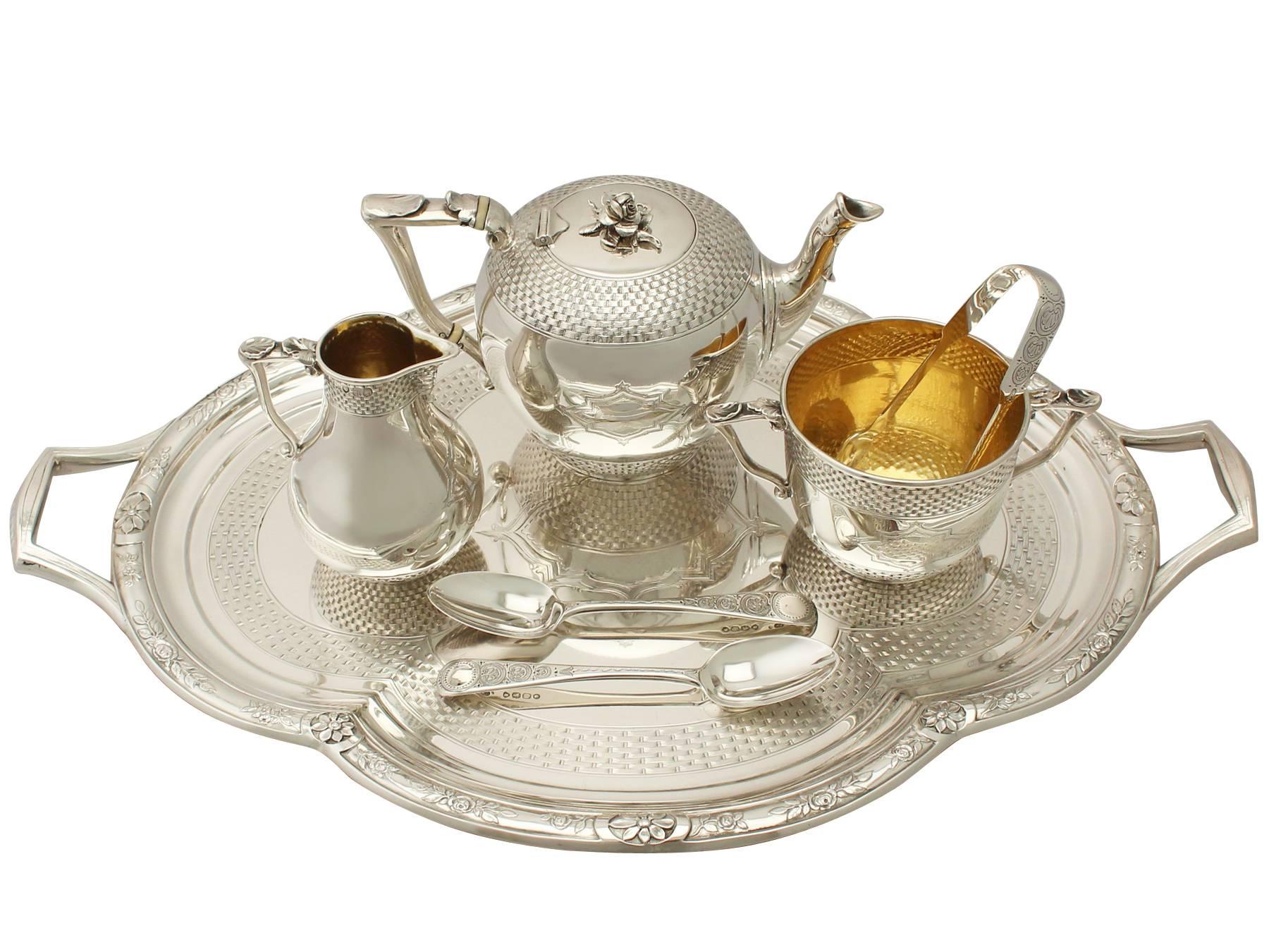 This exceptional antique sterling silver bachelor tea service consists of a teapot, cream jug, sugar bowl and a tea tray.

Each piece of this Victorian silver tea set has a plain circular rounded form onto a collet style base.

The upper and