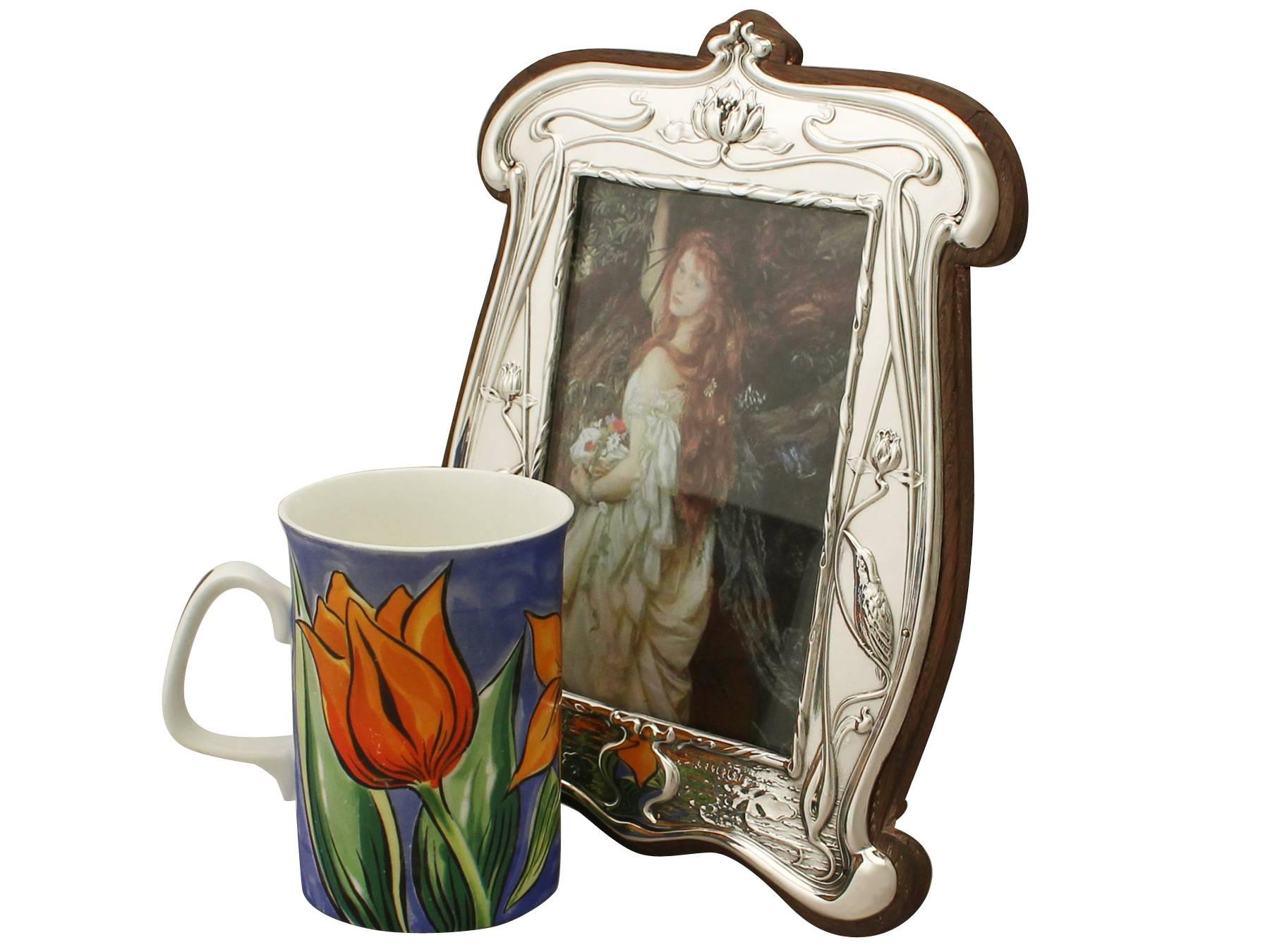 An exceptional, fine and impressive antique Edwardian English sterling silver photograph frame in the Art Nouveau style; an addition to our ornamental silverware collection

This exceptional antique Edwardian sterling silver photograph frame has a