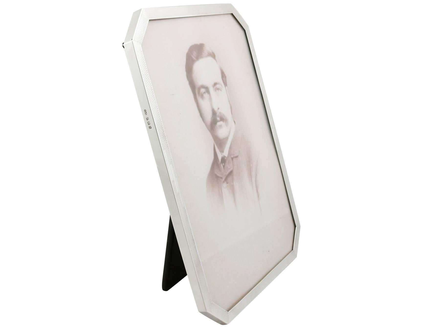 An exceptional, fine and impressive antique George V English sterling silver photograph frame in the Art Deco style; an addition to our collection of ornamental silverware.

This exceptional antique George V sterling silver photograph frame has a