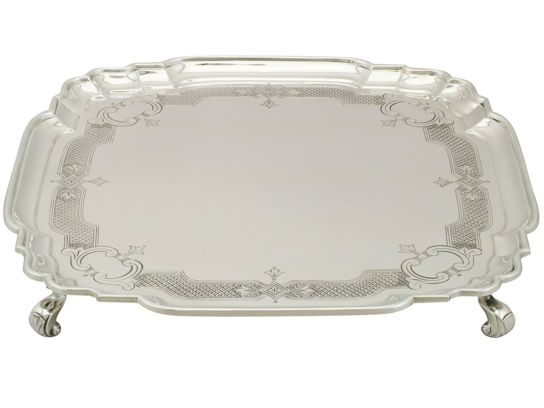 An exceptional, fine and impressive antique George V English sterling silver salver; an addition to our silver dining collection

This exceptional antique George V English silver salver, in sterling standard, has a square shaped form onto four