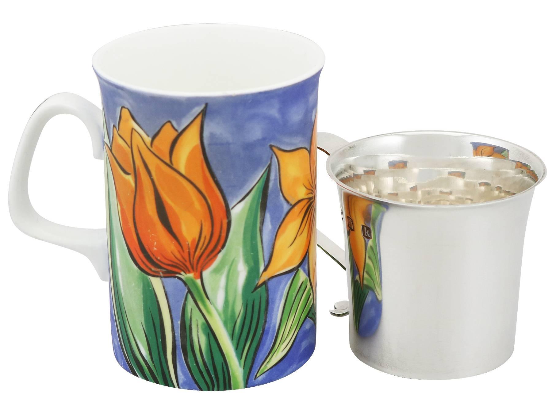 A fine and impressive antique George V English Britannia standard silver christening mug; part of our silver christening gifts collection.

This exceptional antique George V Britannia silver christening mug has a cylindrical tapering form with a