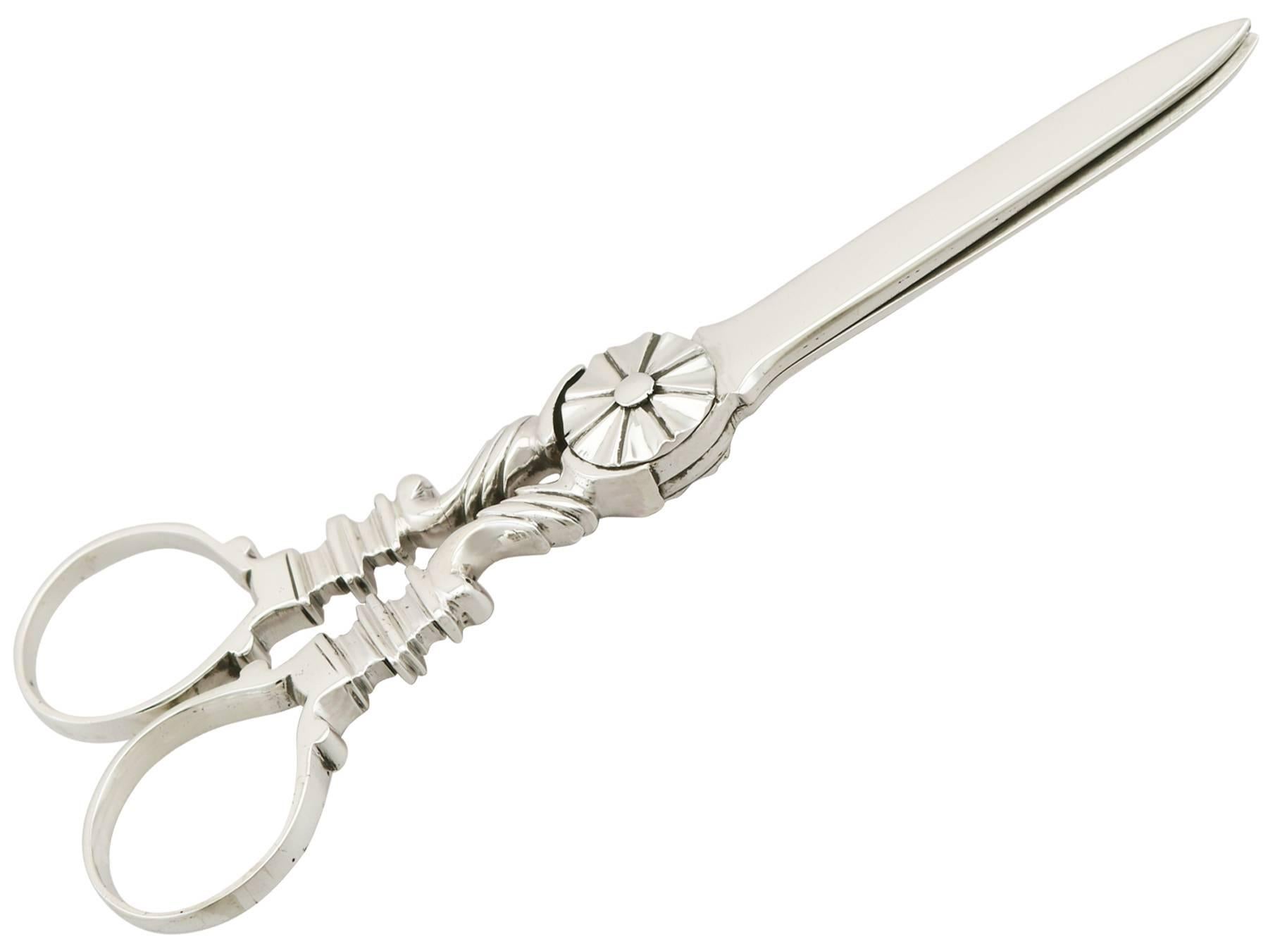 An exceptional, fine and impressive pair of antique George III English sterling silver grape shears; an addition to our silver flatware collection

These exceptional antique George III sterling silver grape shears have a hinged scissor