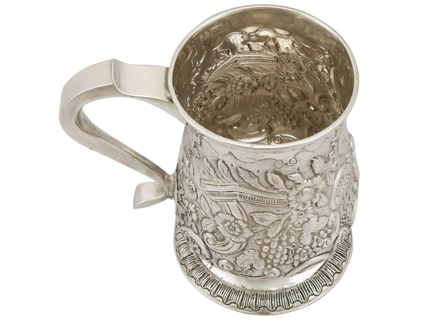 A fine and impressive antique George II sterling silver mug made by John Langlands I; an addition to our range of Georgian silverware collection

This fine antique George II solid silver pint mug has a plain baluster shaped form onto a circular