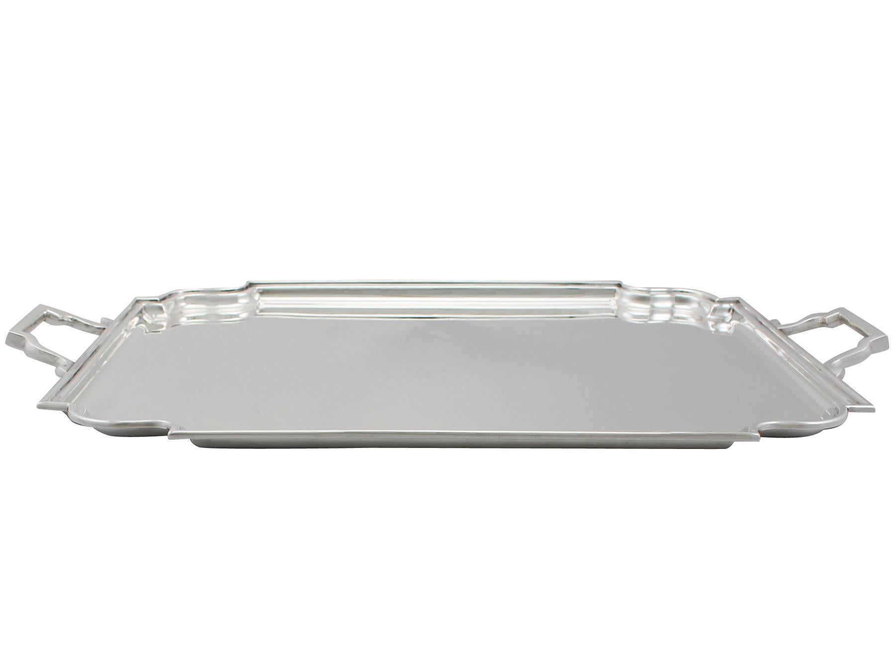 An exceptional, fine and impressive vintage George VI English sterling silver drinks/tea tray in the Art Deco style; an addition to our silver teaware collection

This exceptional vintage George VI sterling silver tea tray has a plain rectangular