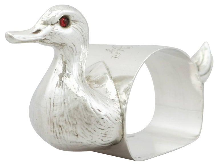 An exceptional, fine and impressive antique George V English sterling silver duck napkin ring; an addition to our christening silverware collection.

This exceptional antique George V sterling silver napkin ring has been realistically modelled in