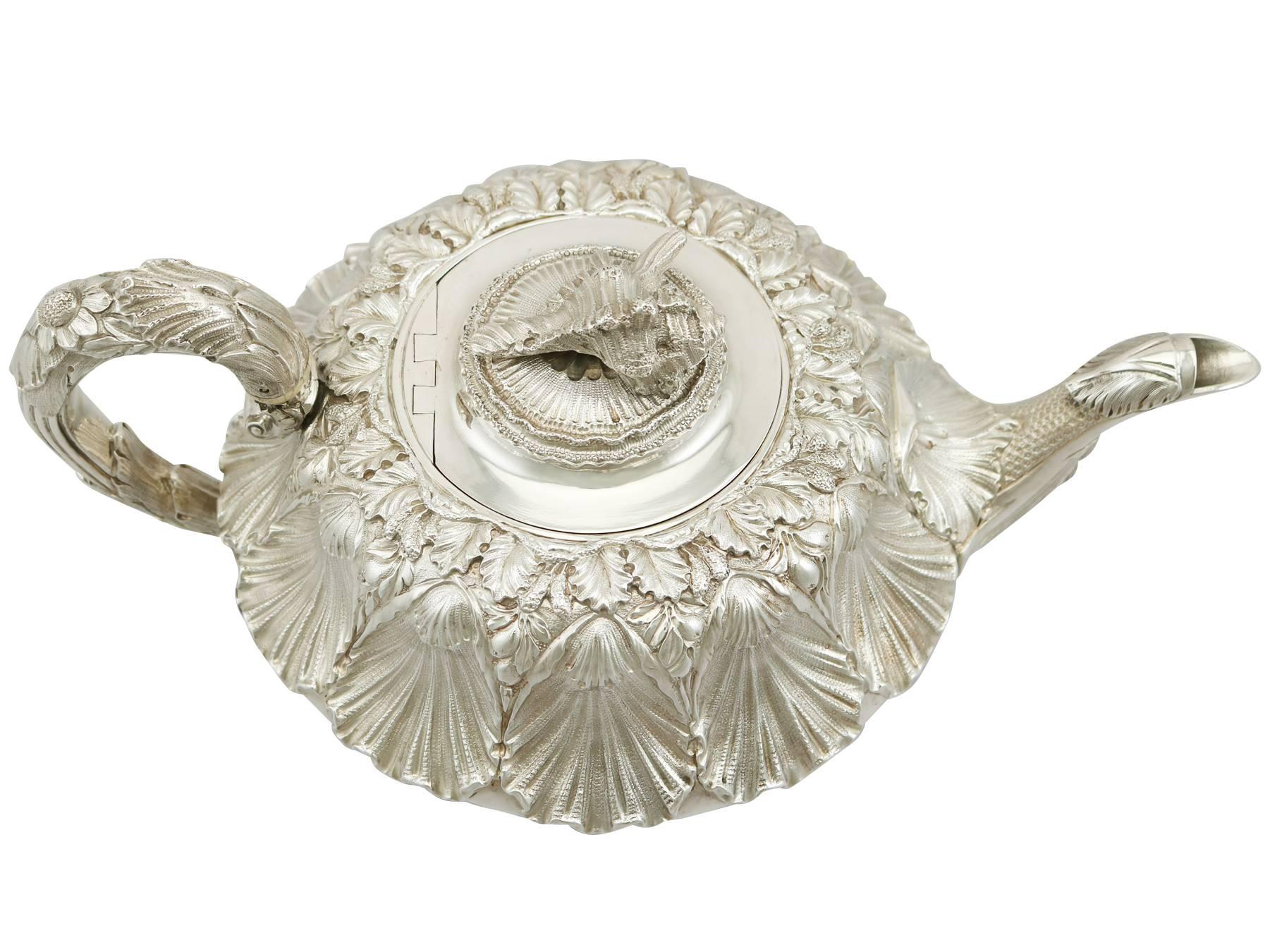 A magnificent, fine and impressive antique George IV English sterling silver teapot made by Charles Thomas Fox; an addition to our silver teaware collection.
This magnificent antique George IV English sterling silver teapot has a circular