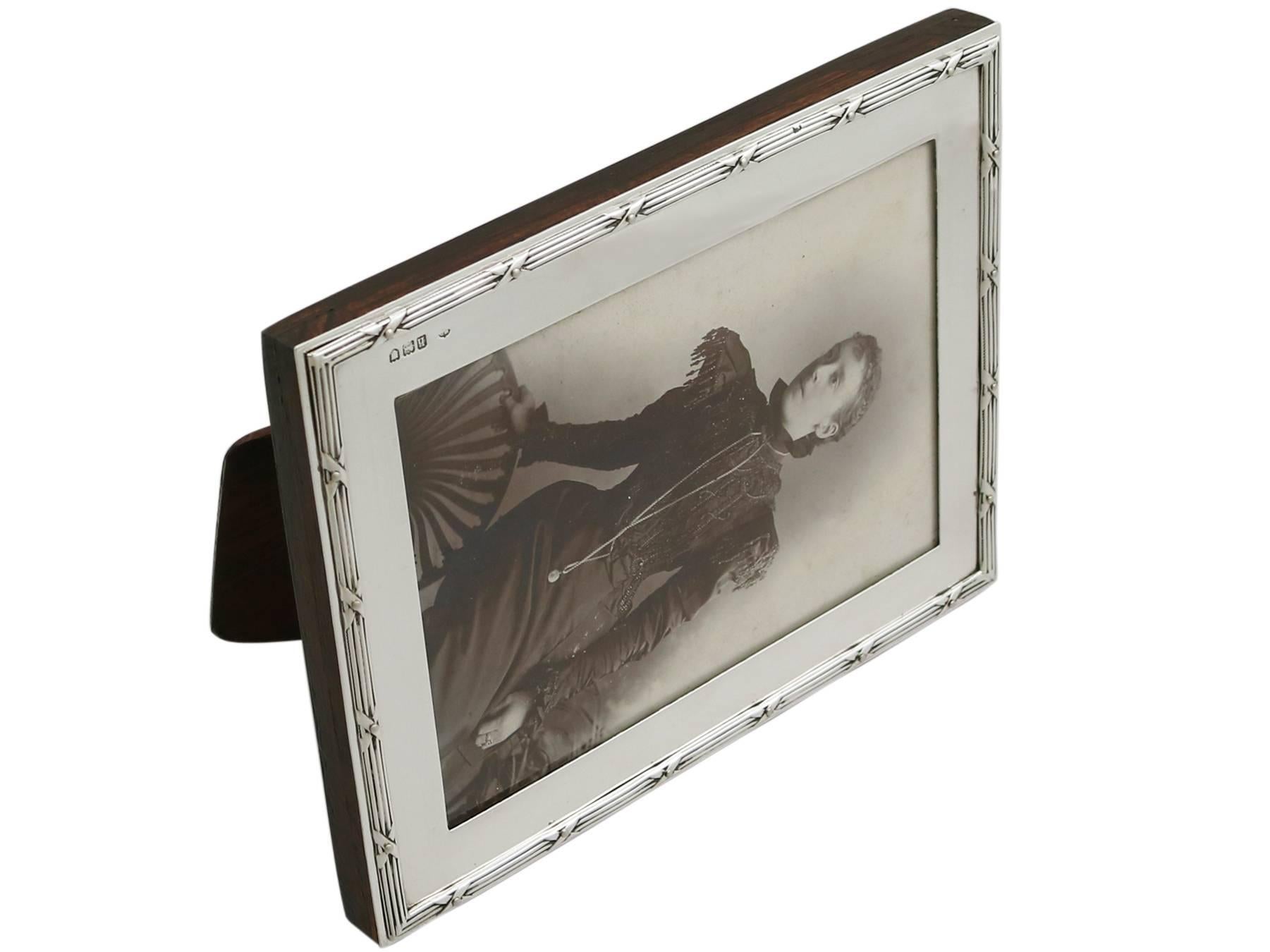 An exceptional, fine and impressive antique Edwardian English sterling silver photograph frame made by William Comyns & Sons; an addition to AC Silver's ornamental silverware collection.

This exceptional antique Edwardian sterling silver