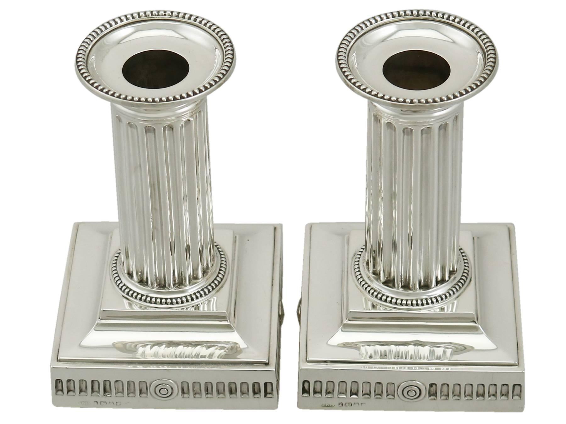 A fine and impressive pair of antique Victorian English sterling silver Corinthian column piano candlesticks; part of our ornamental silverware collection

These exceptional antique Victorian sterling silver candlesticks have Corinthian columns to