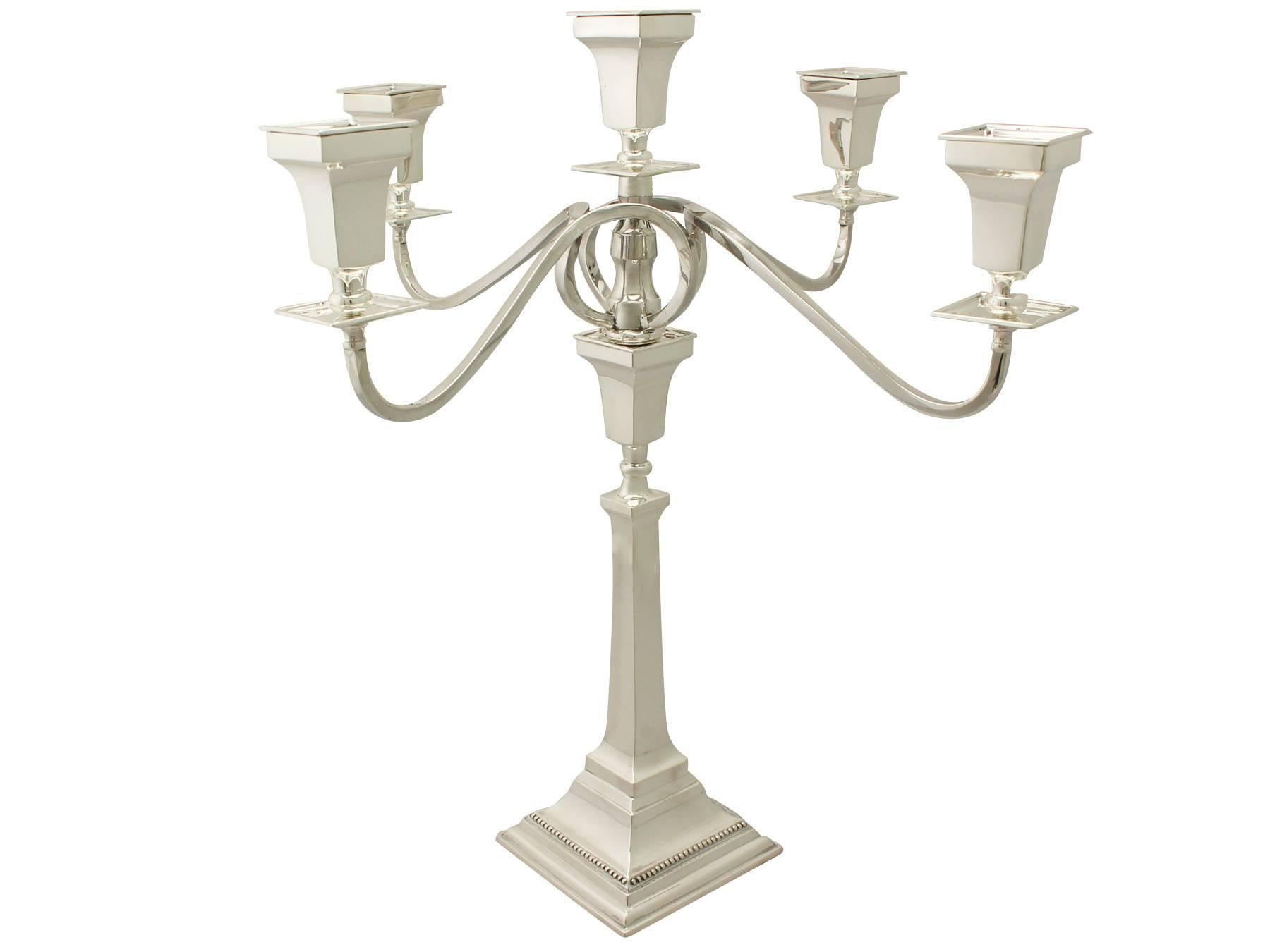 An exceptional, fine and impressive, large antique George VI English sterling silver five-light candelabrum; an addition to our ornamental silverware collection.

This exceptional antique George VI sterling silver five light candelabrum has plain