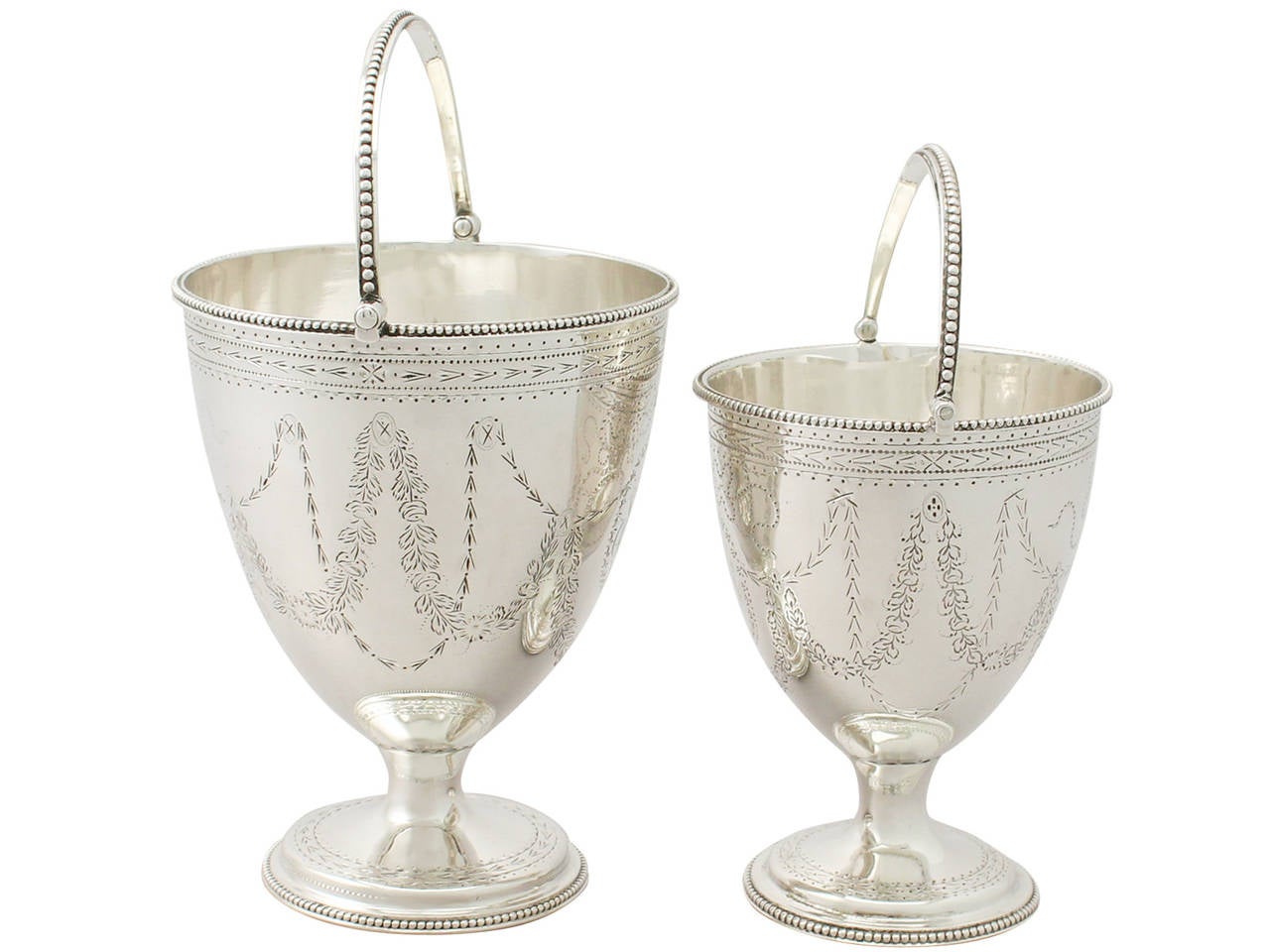 An exceptional, fine and impressive, graduating pair of antique Georgian English sterling silver sugar baskets; an addition to our presentation silverware collection.

These exceptional antique George III English sterling silver swing handled
