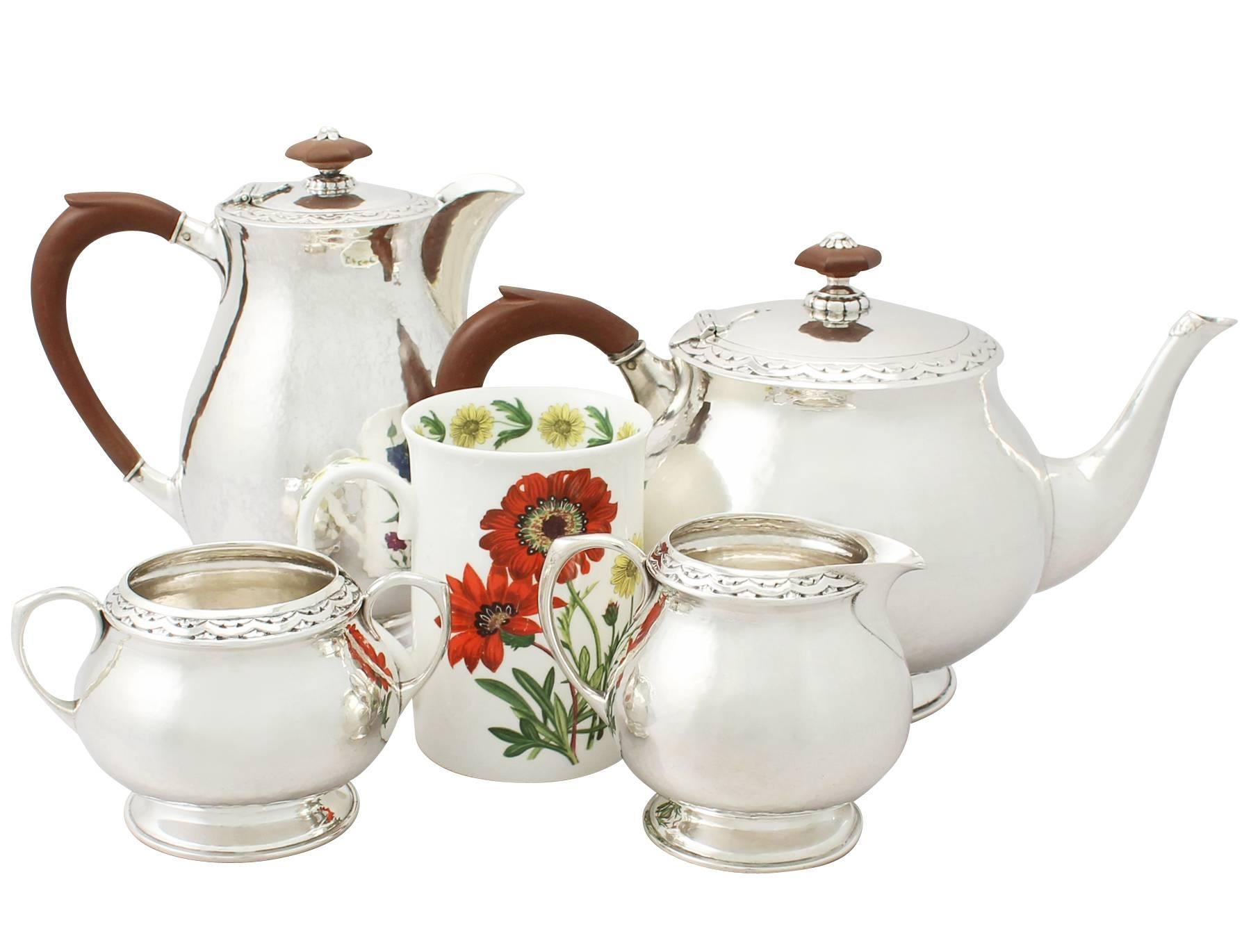 An exceptional, fine antique George V English sterling silver four-piece tea and coffee service / set made by Liberty & Co in the Art Nouveau style; part of our silver teaware collection.

This exceptional antique George V sterling silver tea and