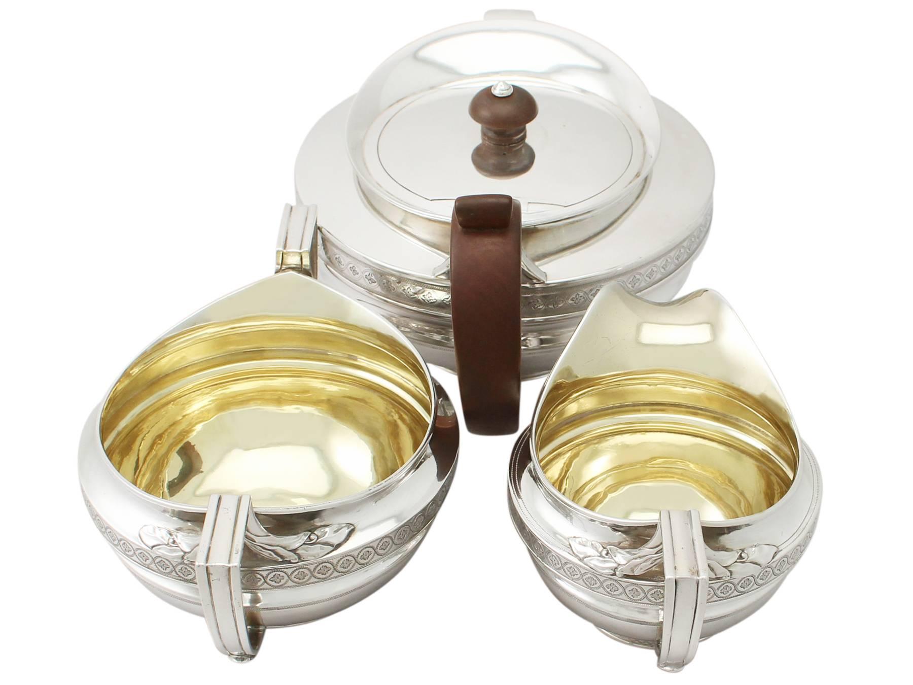 A fine and impressive antique George III English sterling silver three-piece tea service / set; part of our silver teaware collection.

This exceptional antique George III sterling silver three piece tea service consists of a cream jug, a tea pot