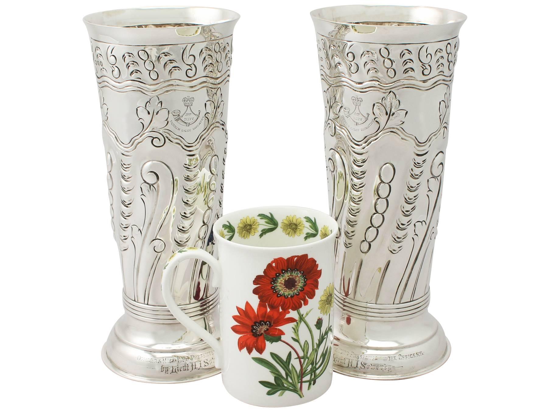 A fine and impressive pair of antique Victorian English sterling silver vases with military interest (Durham Light Infantry); an addition to our ornamental silverware collection.

These fine antique silver vases have a tapering cylindrical form to