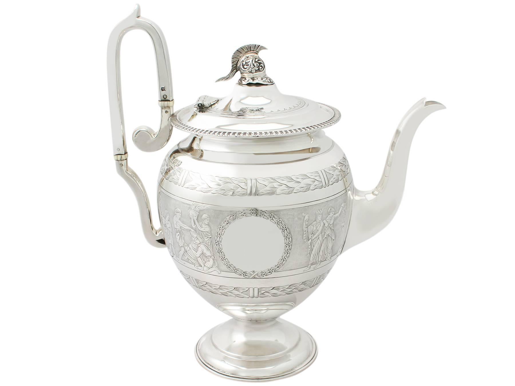 A fine and impressive antique Victorian English sterling silver four-piece tea and coffee service / set; part of our silver teaware collection.
This antique Victorian four piece tea and coffee service consists of a coffee jug, teapot, cream jug /