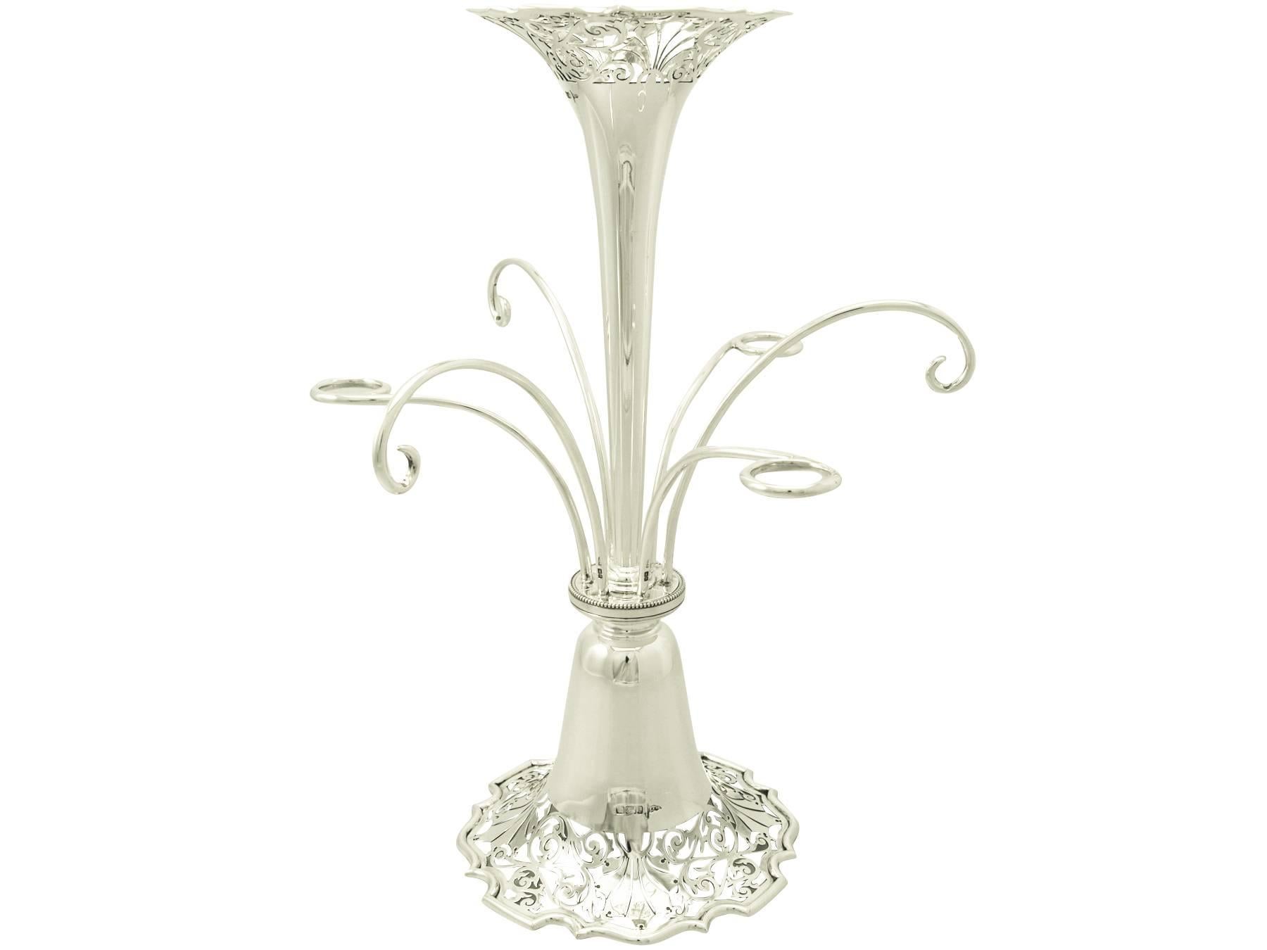 An exceptional, large and impressive antique Edwardian English sterling silver centrepiece; part of our ornamental silverware collection.

This exceptional and large antique Edwardian sterling silver epergne/centrepiece has a plain, tapering form