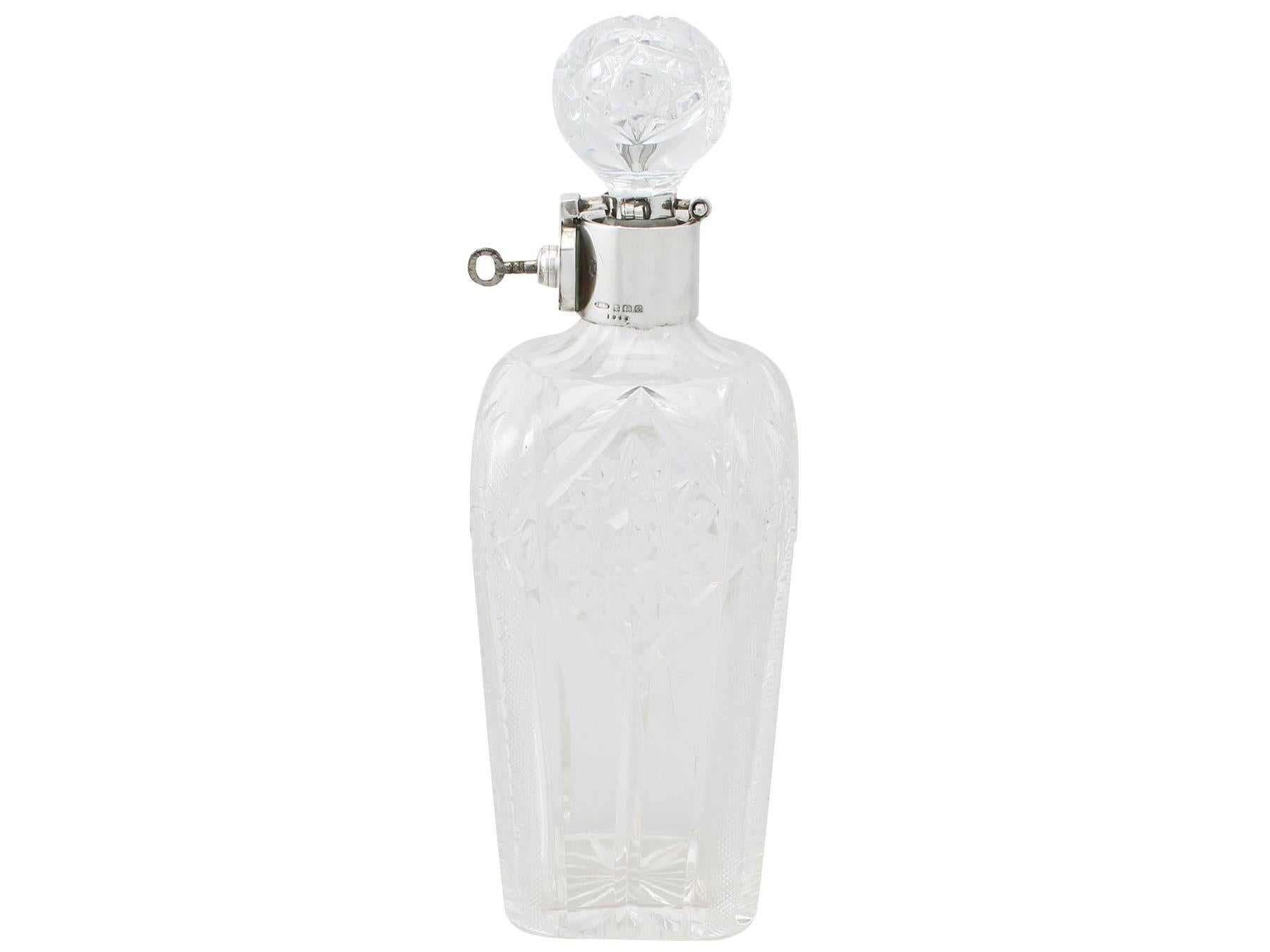 A fine and impressive, unusual antique George V English cut glass and sterling silver mounted locking decanter; an addition to our sterling silver lounge collection.

This fine antique George V cut glass and sterling silver mounted decanter has a