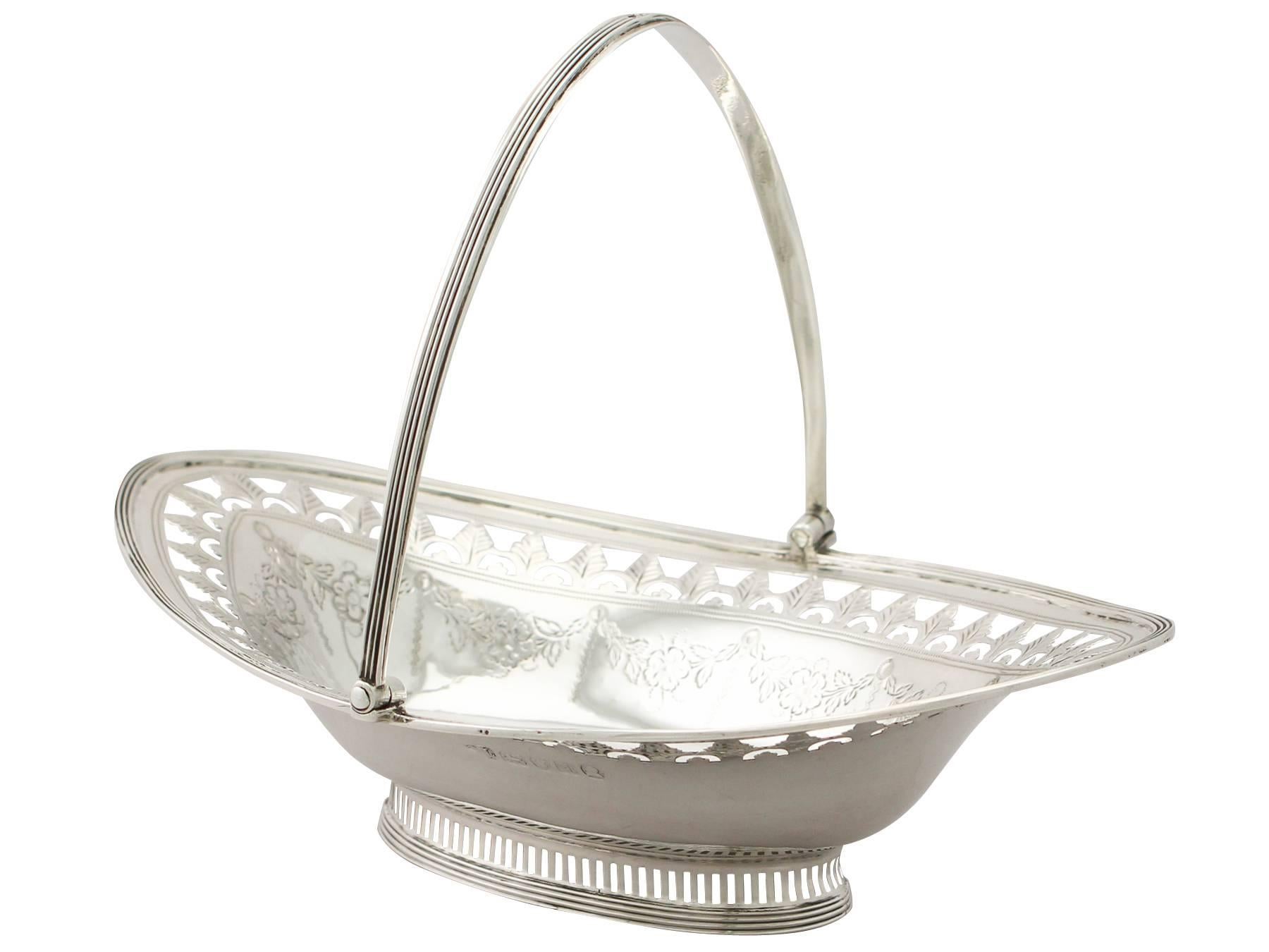 A fine antique Georgian English sterling silver swing-handled sweetmeat basket; an addition to our ornamental silverware collection

This fine antique Georgian sterling silver basket has an oval rounded navette shaped form onto an oval collet style