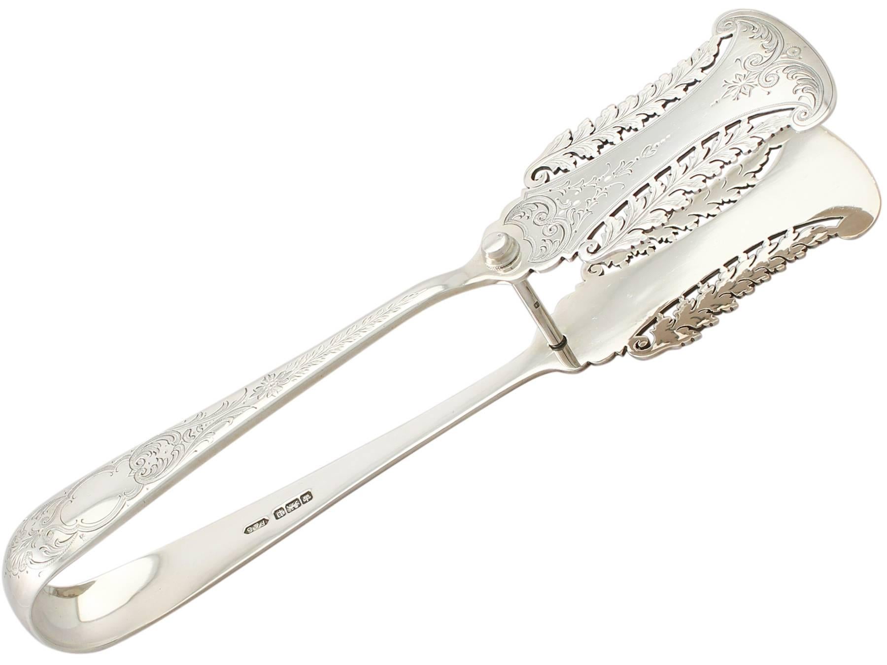 A fine pair of antique Edwardian English sterling silver serving tongs; an addition to our silverware collection

These fine antique Edwardian sterling silver serving tongs have a rounded rectangular form.

The shaped blades of these silver