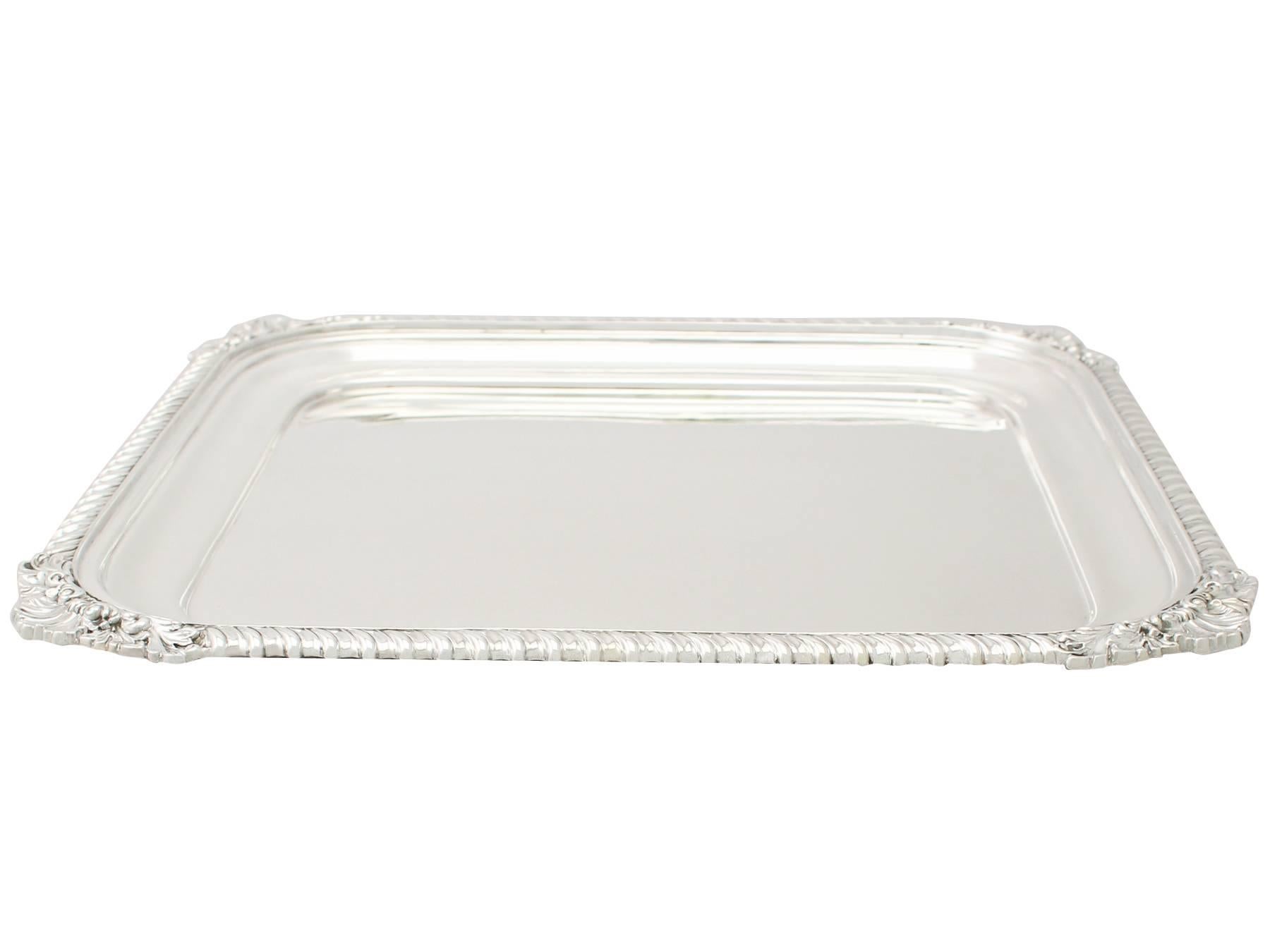 A fine and impressive antique George V English sterling silver square shaped salver; an addition to our dining silverware collection.

This fine antique George V sterling silver salver has a plain square form with rounded corners.

The surface