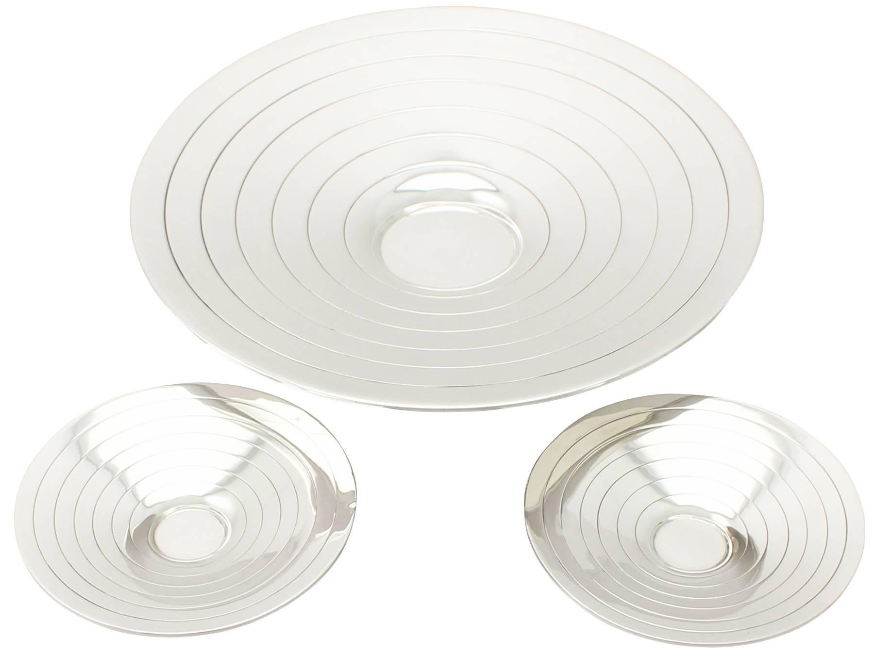 A fine and impressive suite of three antique George V English sterling silver dishes – Art Deco style; an addition to our dining silverware collection

These fine antique George V sterling silver dishes have a circular flared form onto a stepped