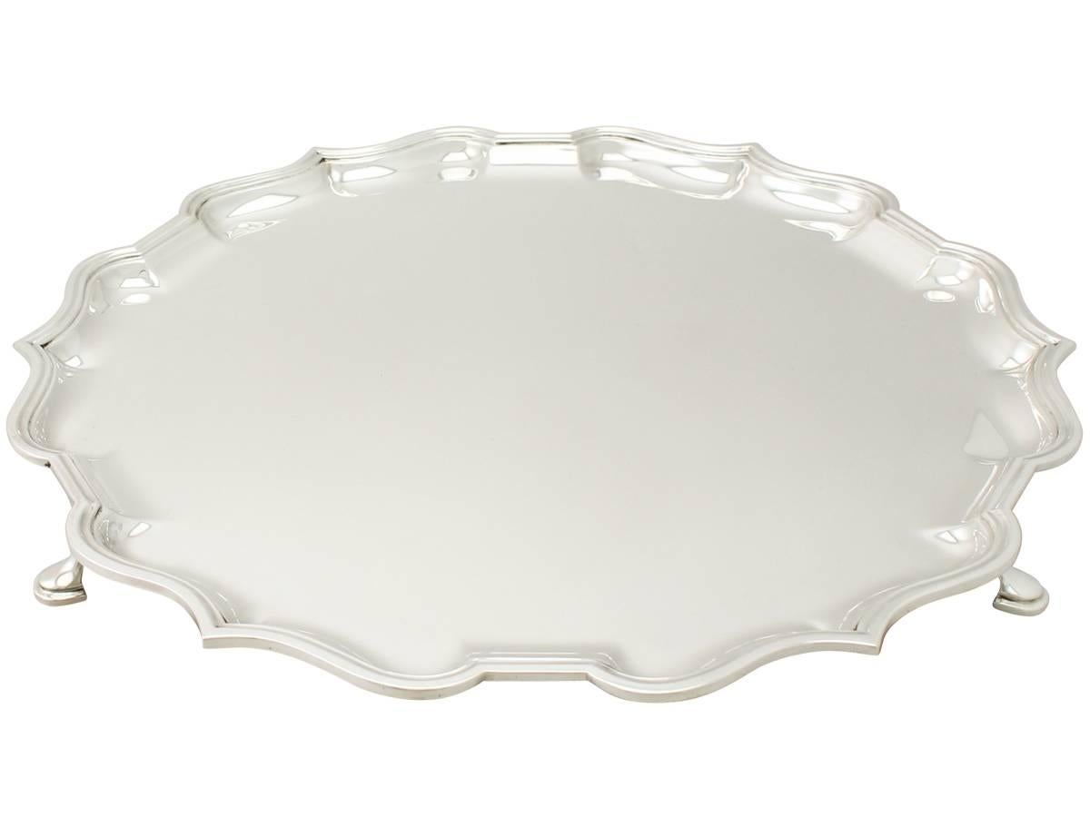 A fine and impressive vintage George VI English sterling silver salver; an addition to our silver dining collection.

This fine vintage George VI English sterling silver salver has a circular shaped form onto four feet.

The surface of this