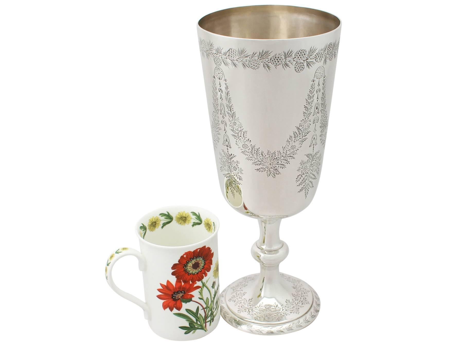 A fine and impressive antique Victorian English sterling silver presentation cup / trophy; part of our silverware collection.

This impressive antique Victorian sterling silver cup/trophy has a circular tapering, bell shaped form to a knopped