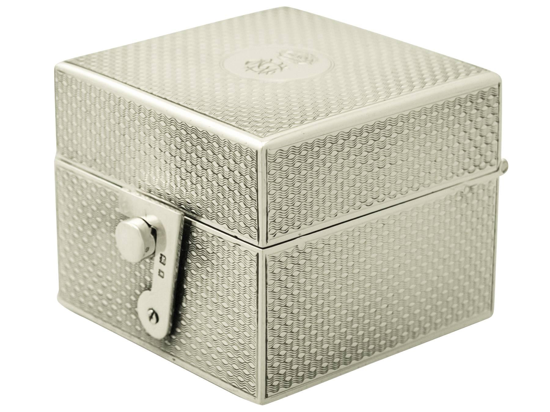 A fine and impressive antique George V English sterling silver travelling inkwell; an addition to our diverse ornamental silverware collection.

This fine antique George V sterling silver travelling inkwell has a plain square shaped form.

The