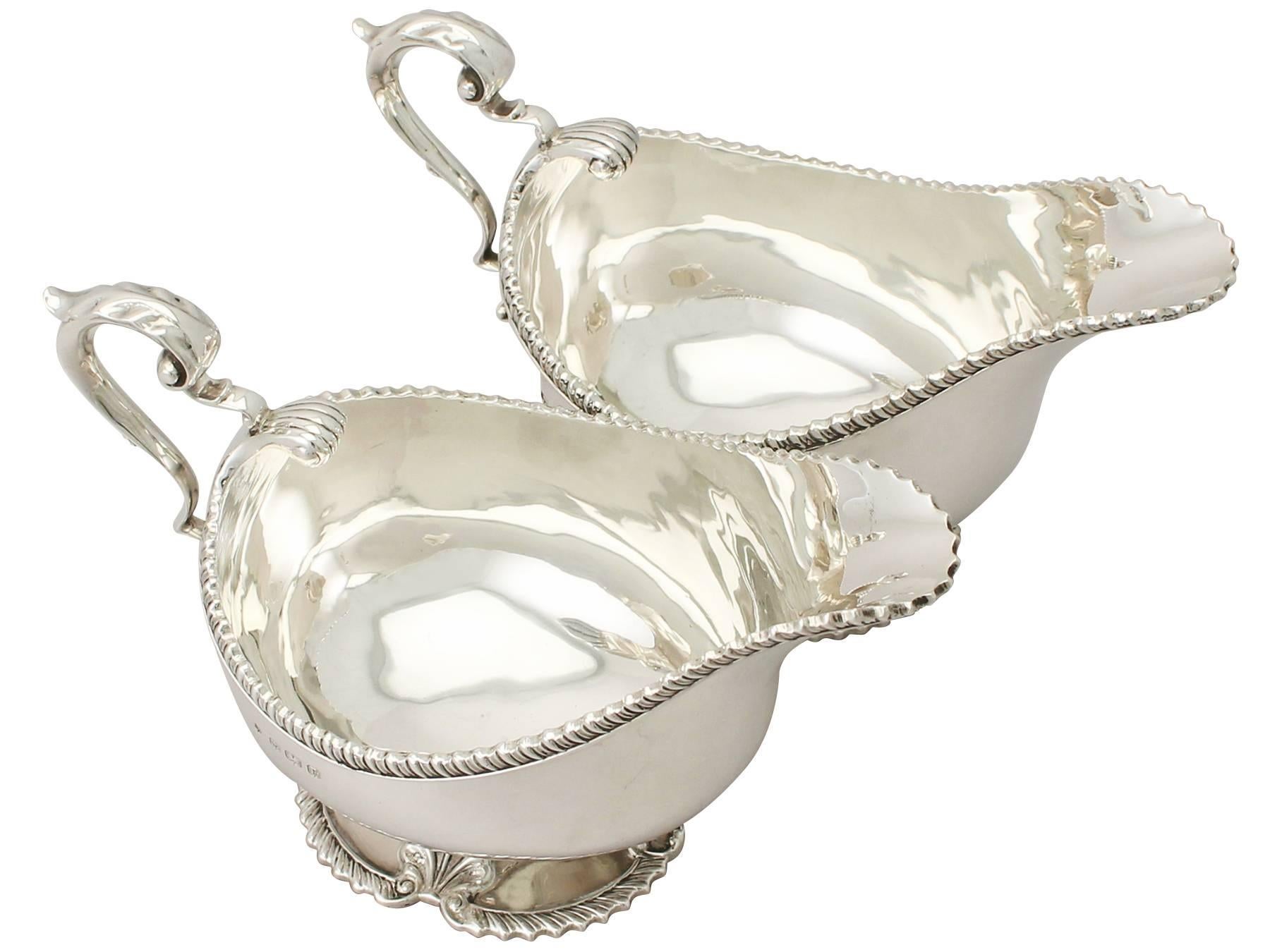 An exceptional, fine and impressive pair of antique George V sterling silver Regency style sauceboats; an addition to our dining silverware collection.

These exceptional antique George V sterling silver sauce boats have a plain oval rounded form