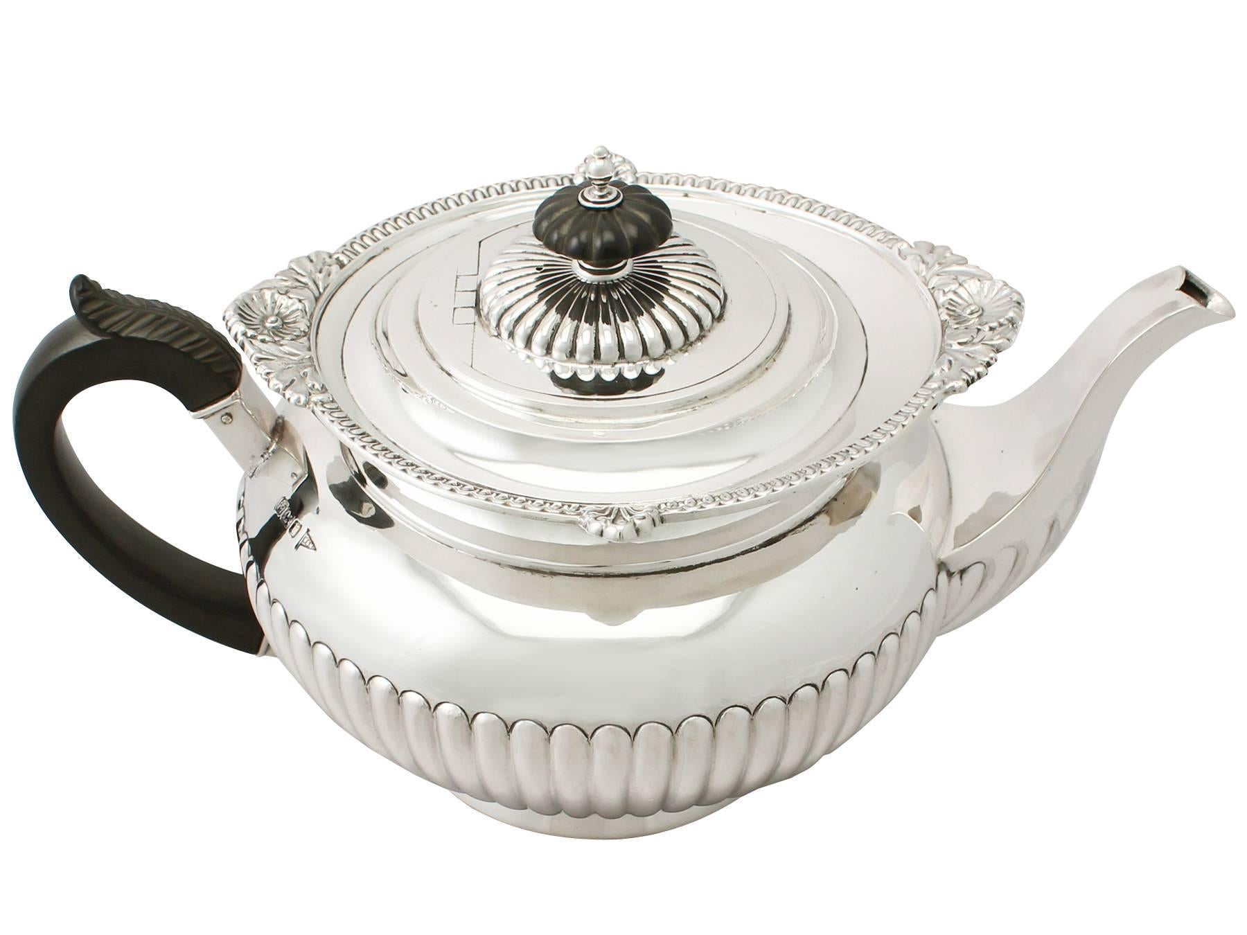 An exceptional, fine and impressive antique Edwardian English sterling silver teapot; an addition to our silver teaware collection.

This exceptional antique Edwardian sterling silver teapot has an circular rounded form onto a plain collet style